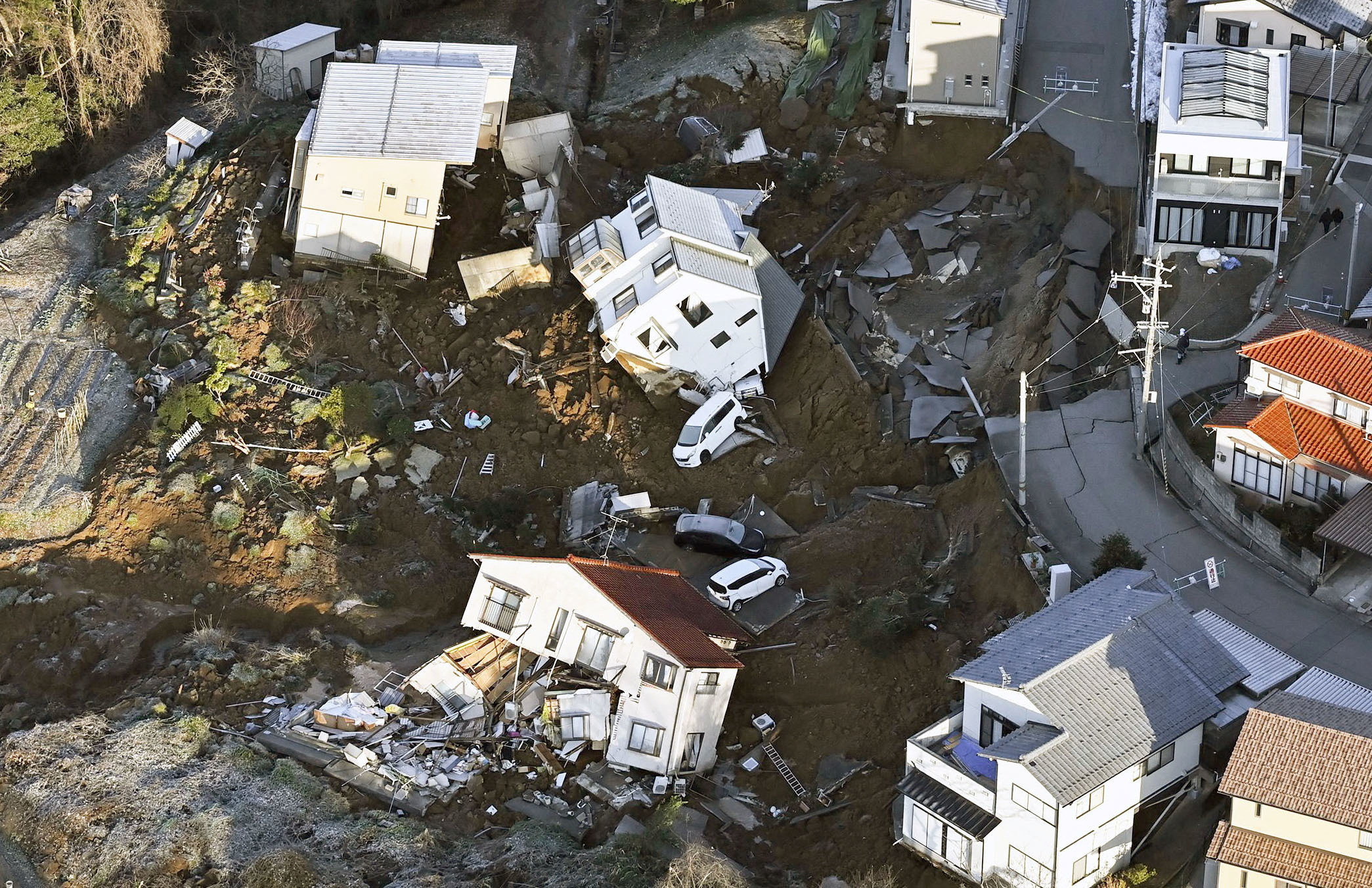 An aerial view shows collapsed houses, cars and roads caused by an earthquake in Kanazawa