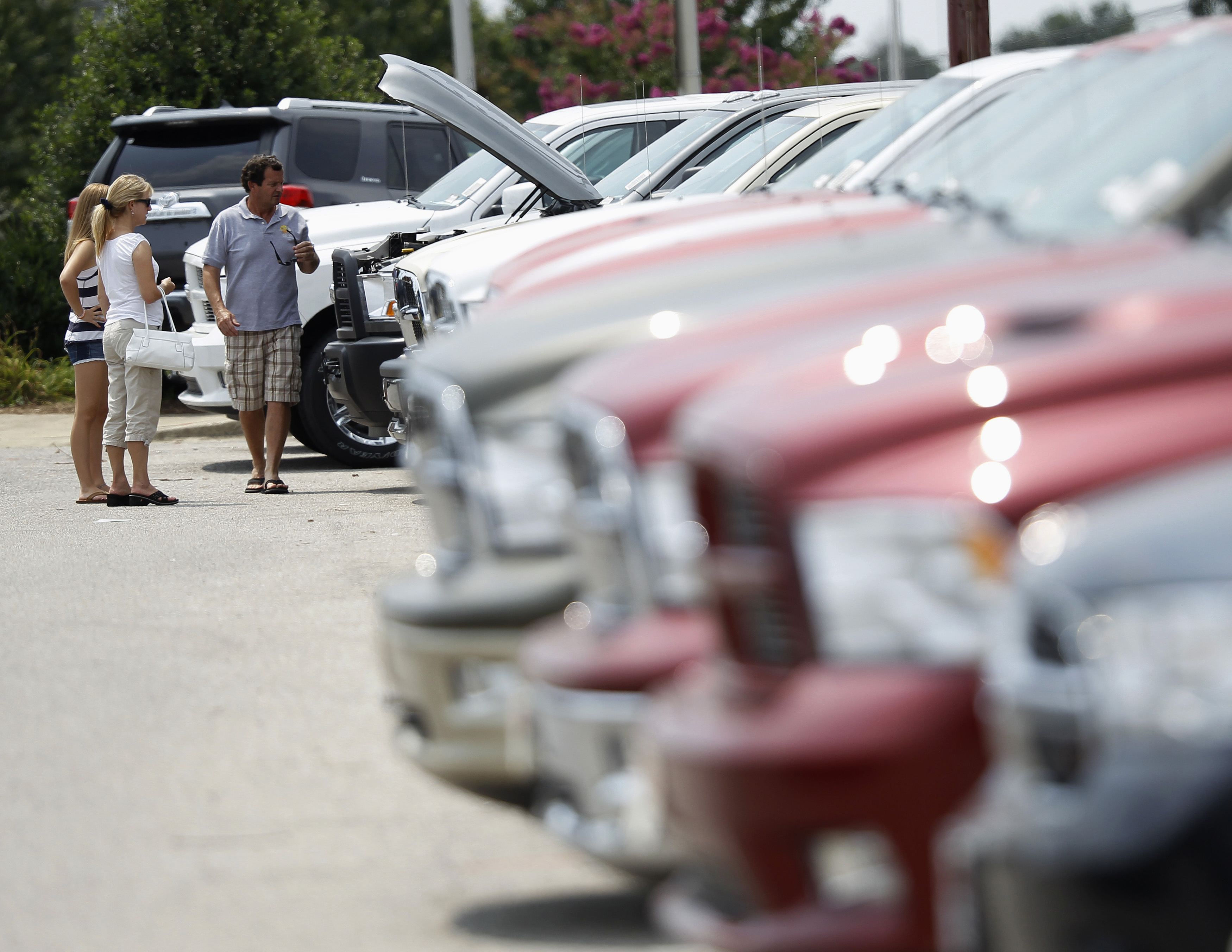 FILE PHOTO - A family looks at Dodge Ram pick up trucks in Silver Spring Maryland
