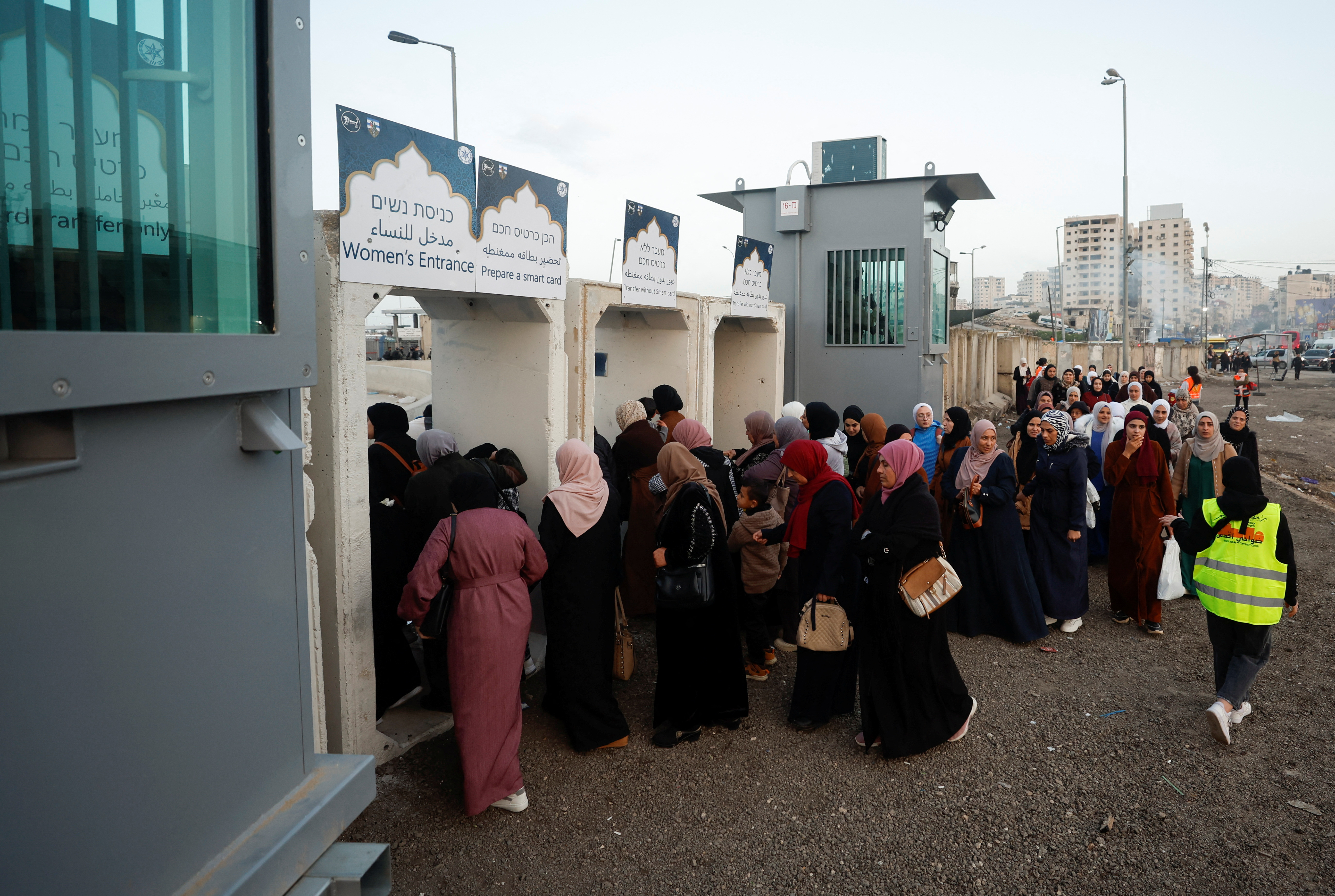 Palestinians make their way to attend the first Friday prayers of Ramadan at Qalandia checkpoint