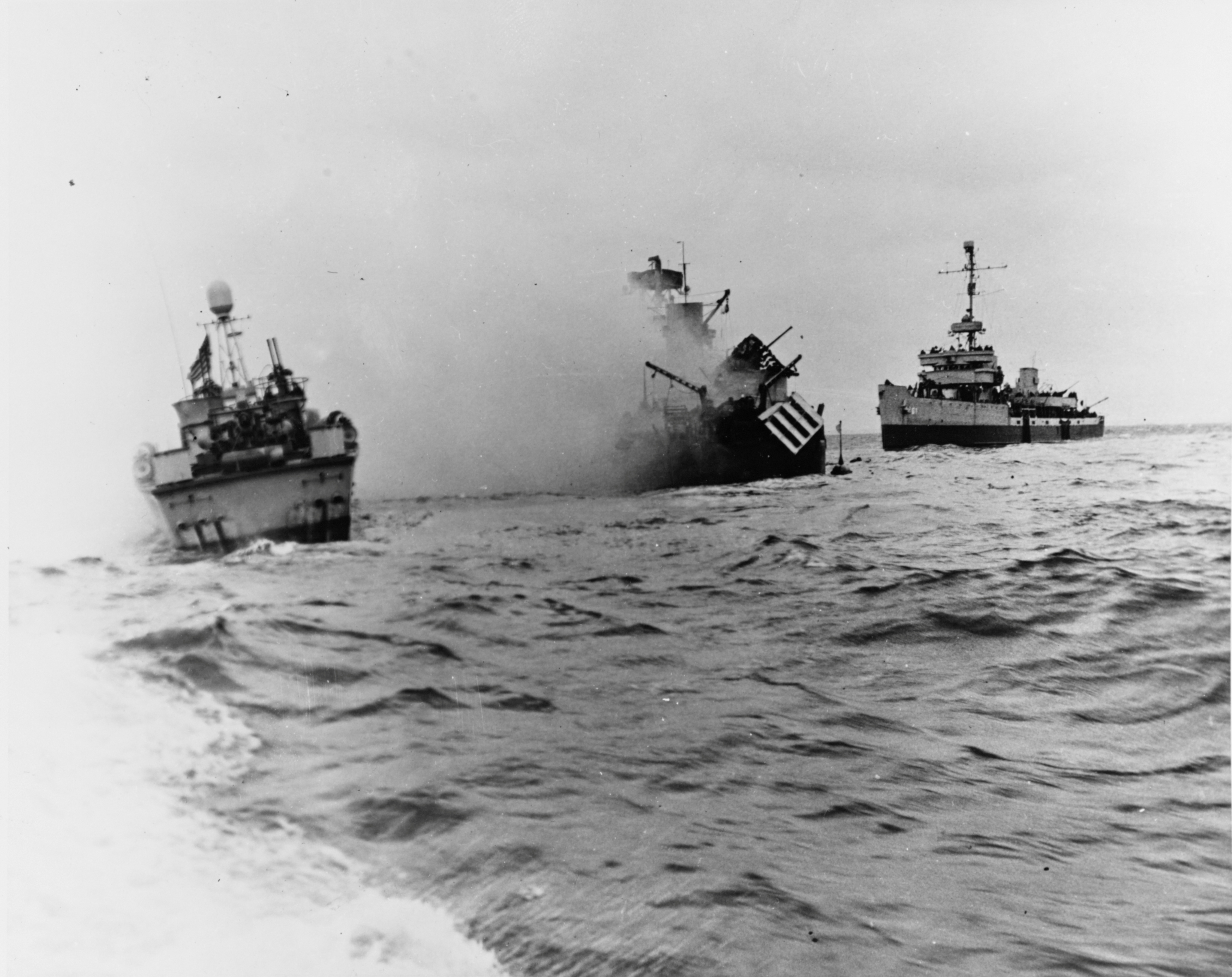 The U.S. Navy minesweeper USS Tide sinks after striking a mine during the D-Day landings on Utah Beach in Normandy