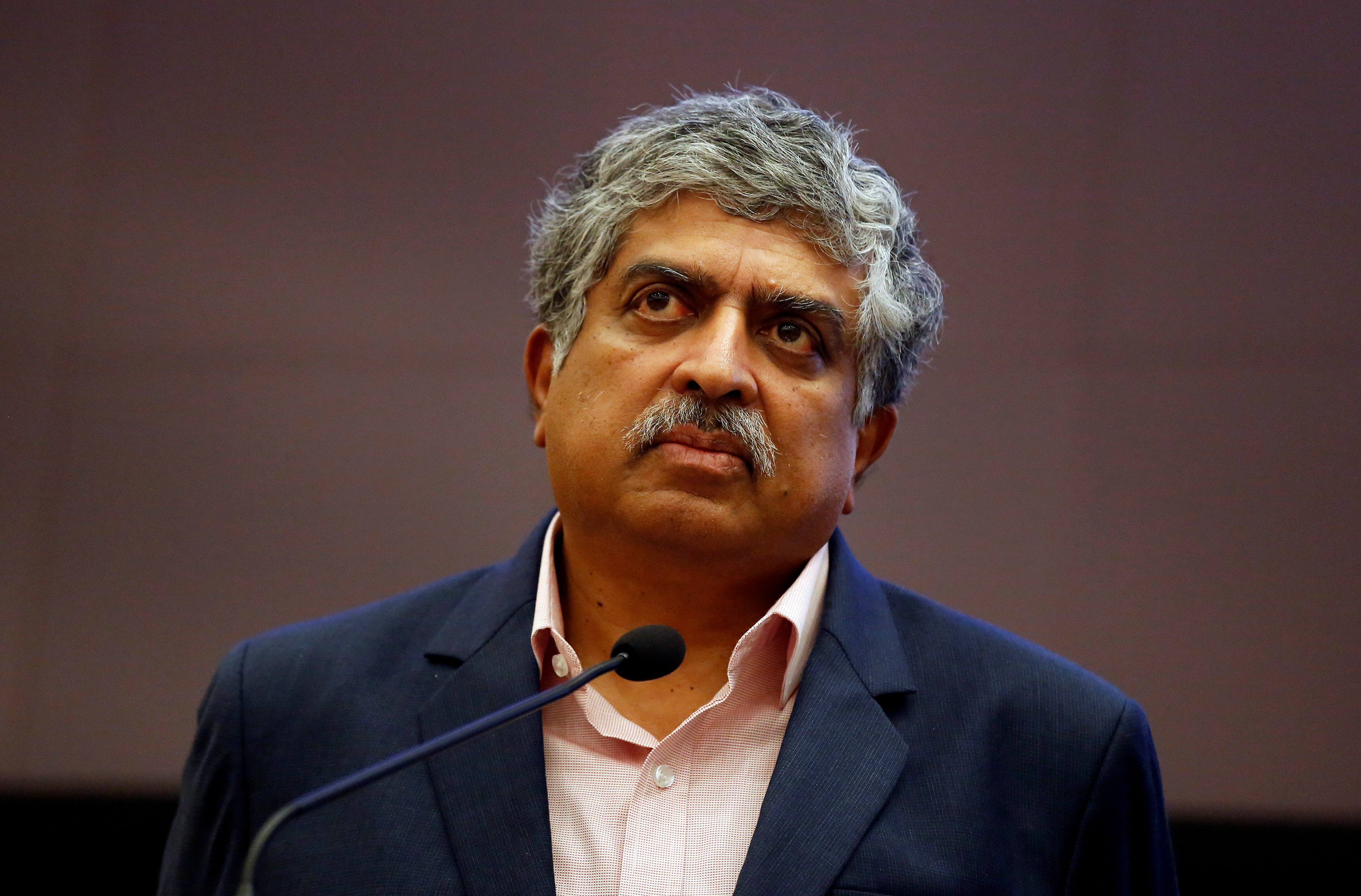 Nandan Nilekani, Co-founder and Non-Executive Chairman of Infosys, listens to reporters' questions during the announcement of the company's quarterly results at its headquarters in Bengaluru, India, January 12, 2018. REUTERS/Abhishek N. Chinnappa