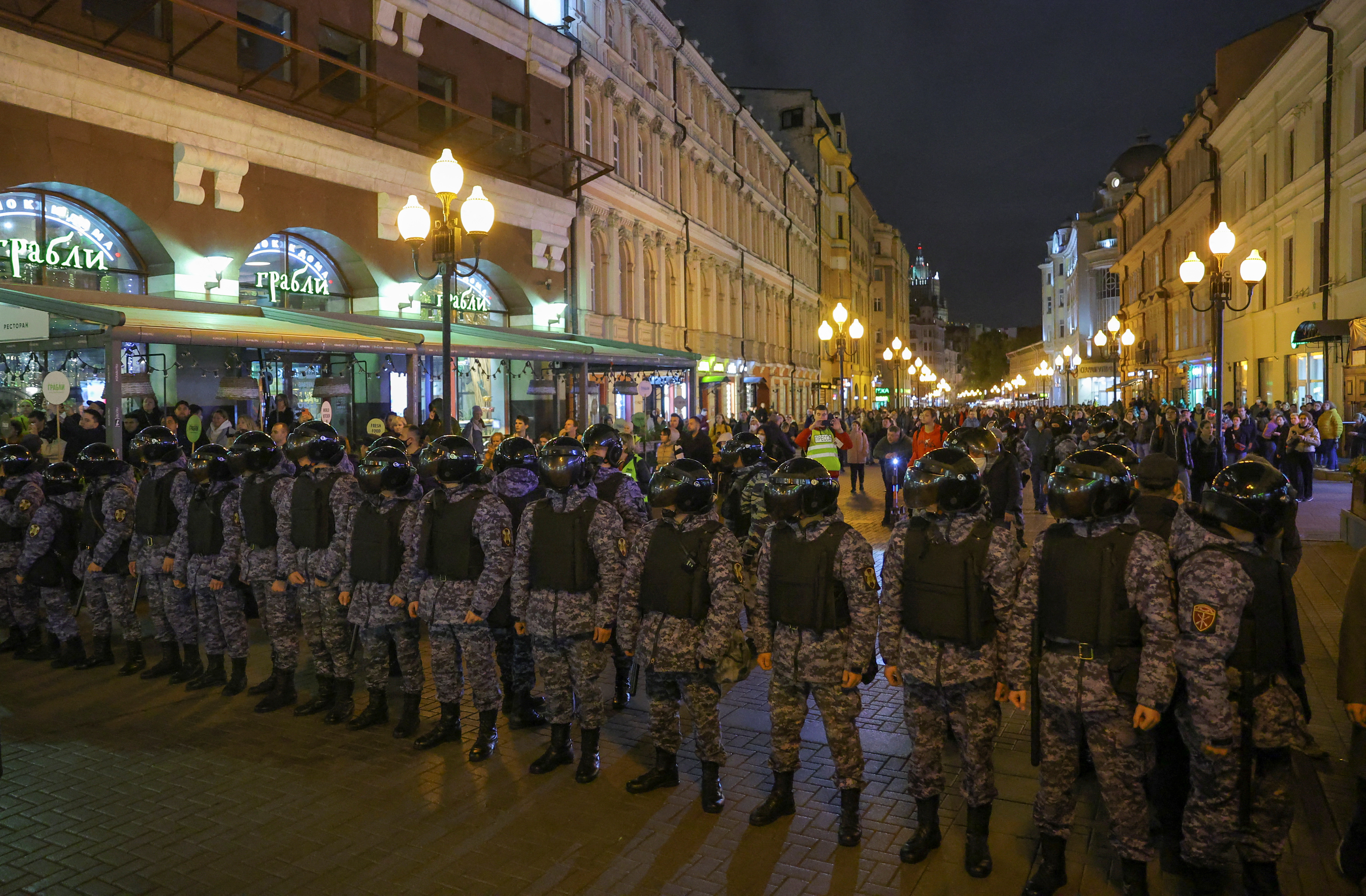Russian police officers stand guard during an unsanctioned rally in Moscow