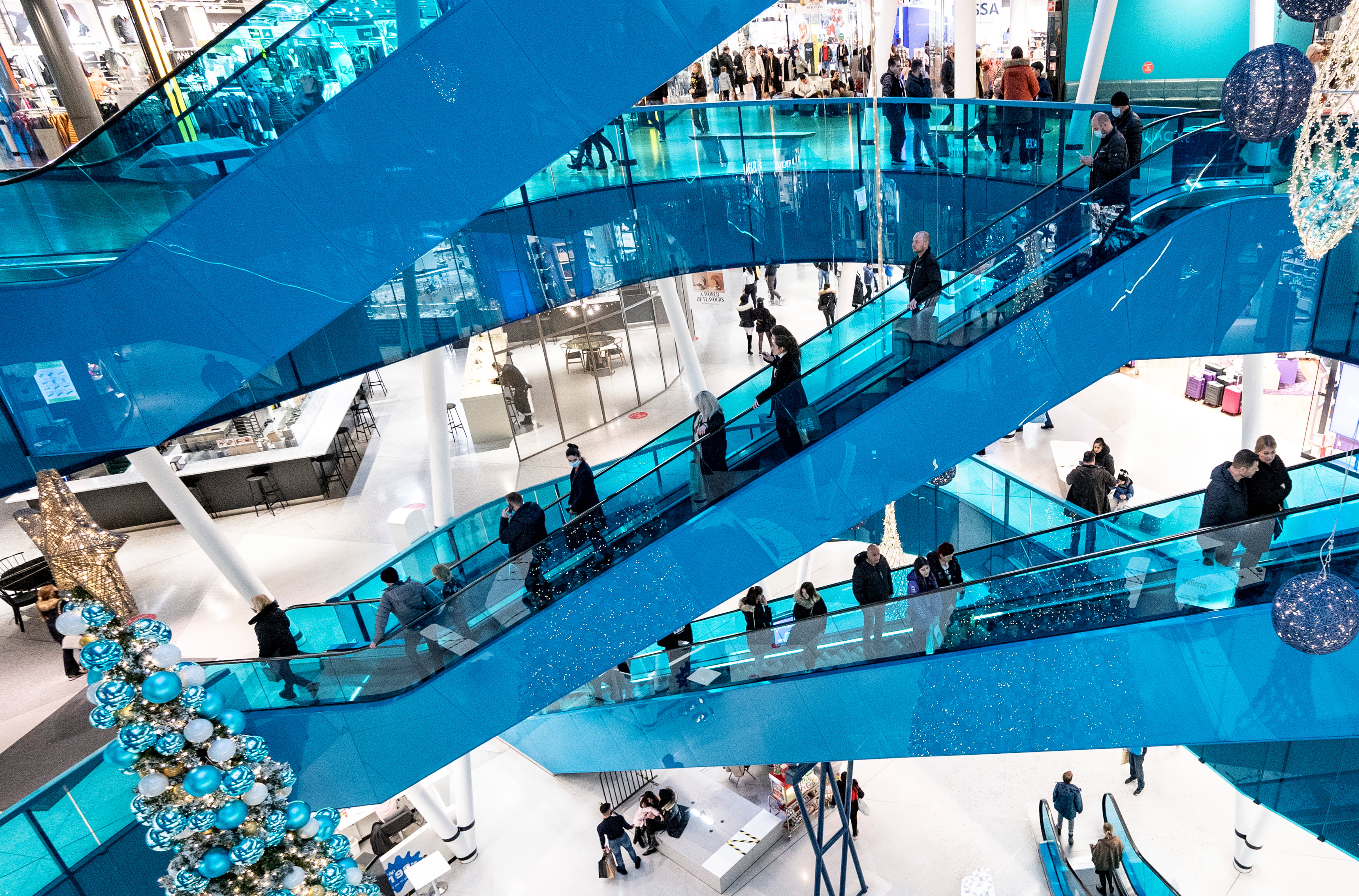 Christmas shoppers maintain social distancing as they ride on escalators in Emporia shopping centre in Malmo