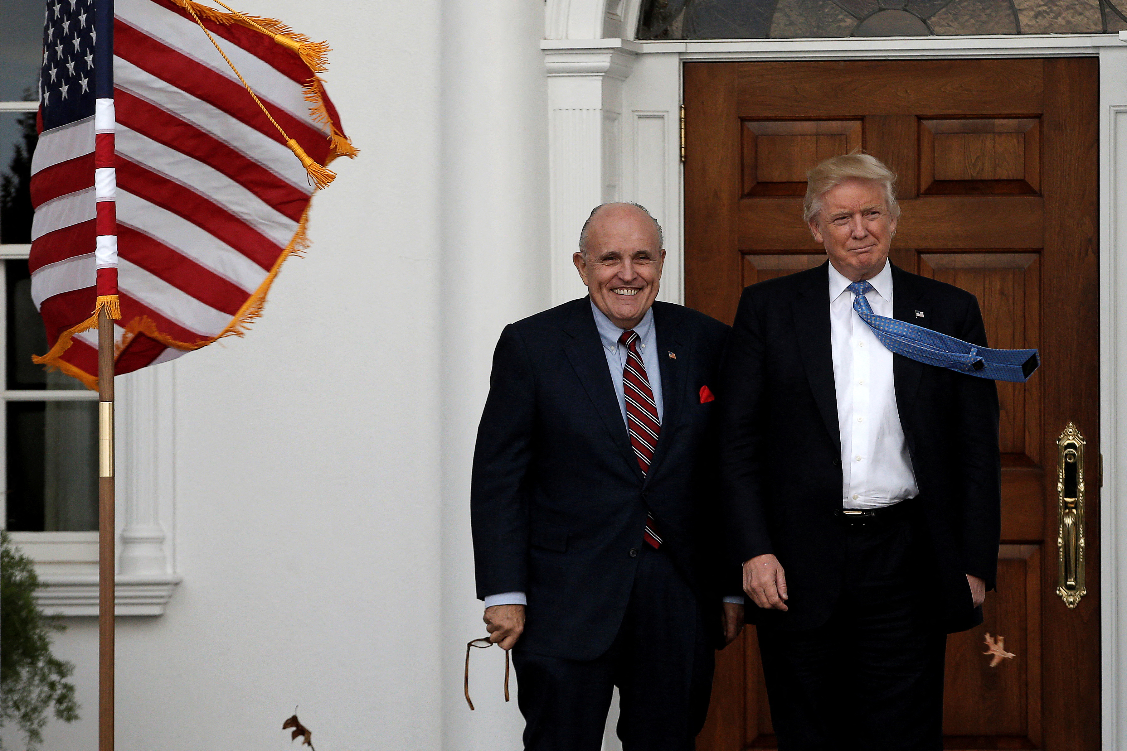 U.S. President-elect Donald Trump stands with former New York City Mayor Rudolph Giuliani before their meeting at Trump National Golf Club in Bedminster