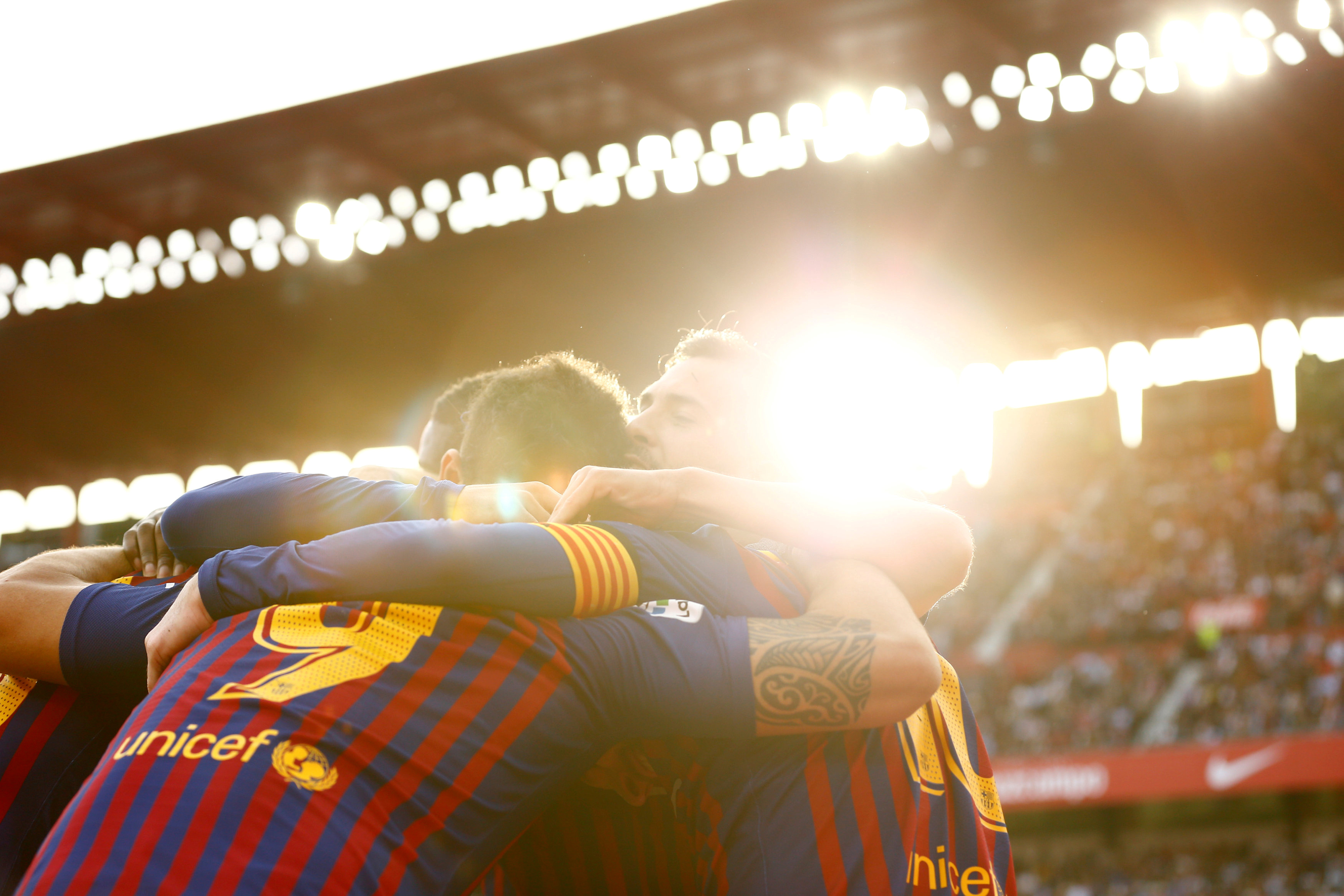 Barcelona's Lionel Messi celebrates with team mates after scoring their third goal to complete his hat-trick