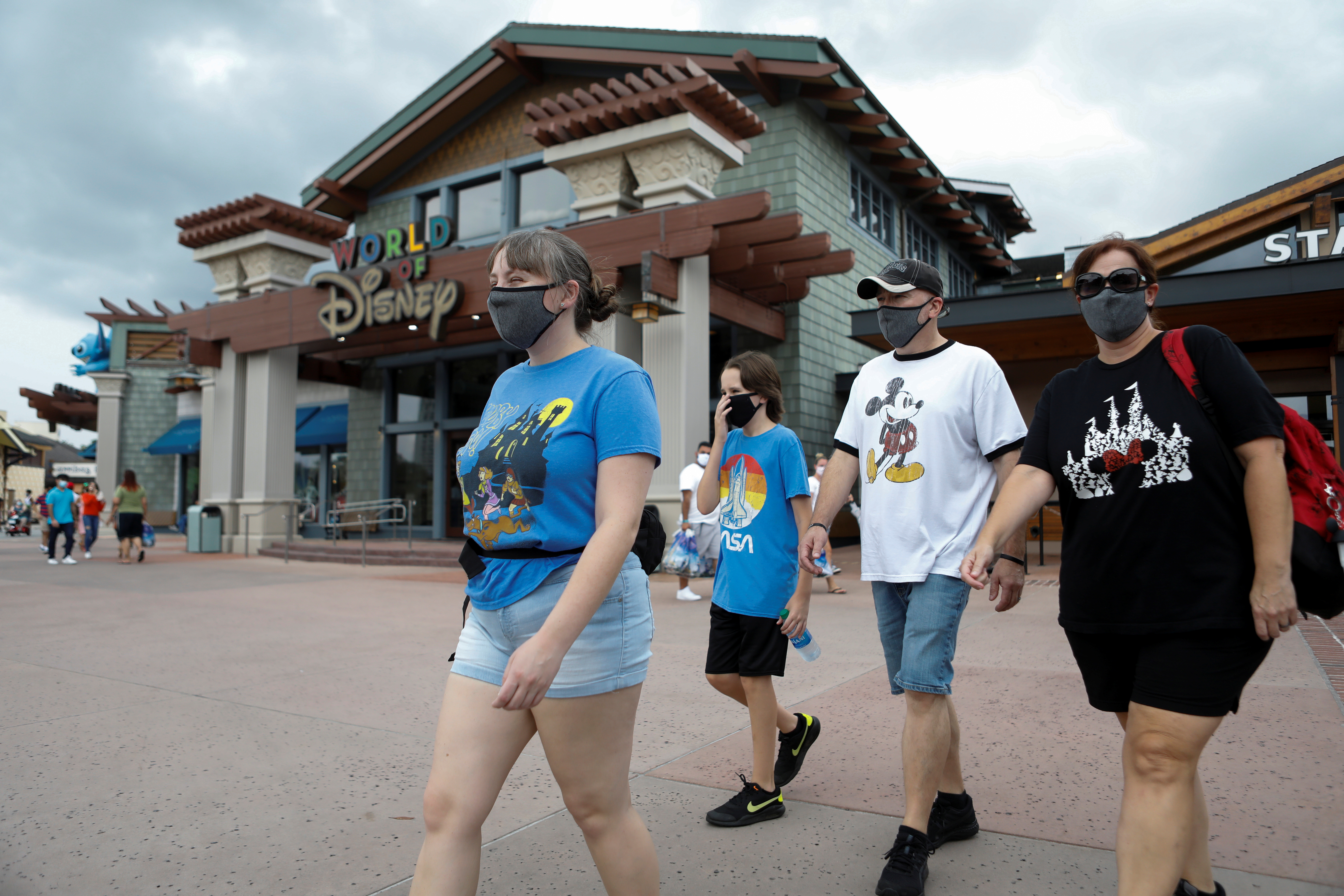 Summer Selmon, her brother Levi, and their parents Dave and Brandi wear face masks while visiting the Disney Springs shopping and dining district during their vacation at Walt Disney World during a phased reopening from coronavirus disease (COVID-19) restrictions in Lake Buena Vista, Florida, U.S. July 11, 2020. REUTERS/Octavio Jones