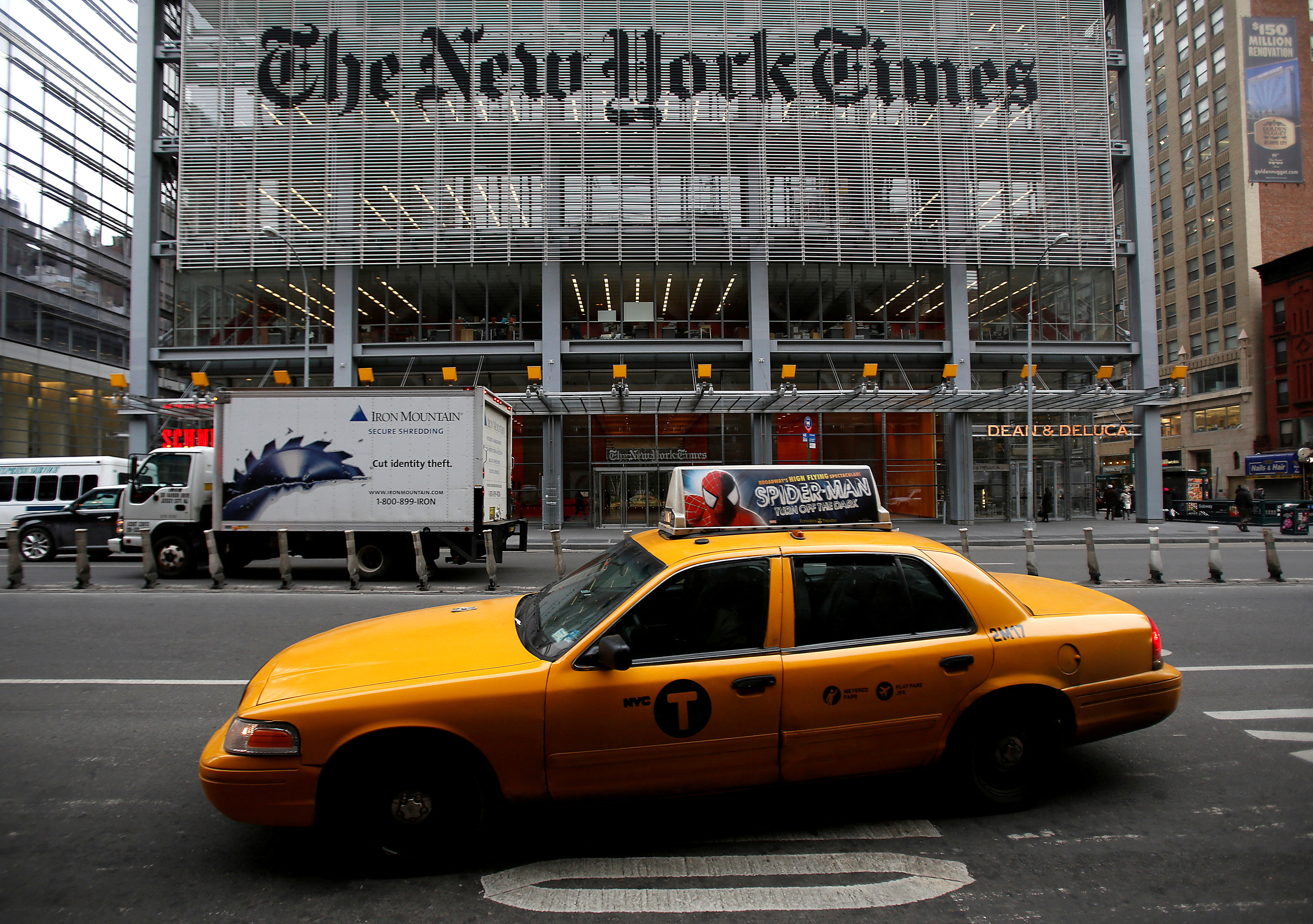 A taxi passes by in front of The New York Times head office in New York