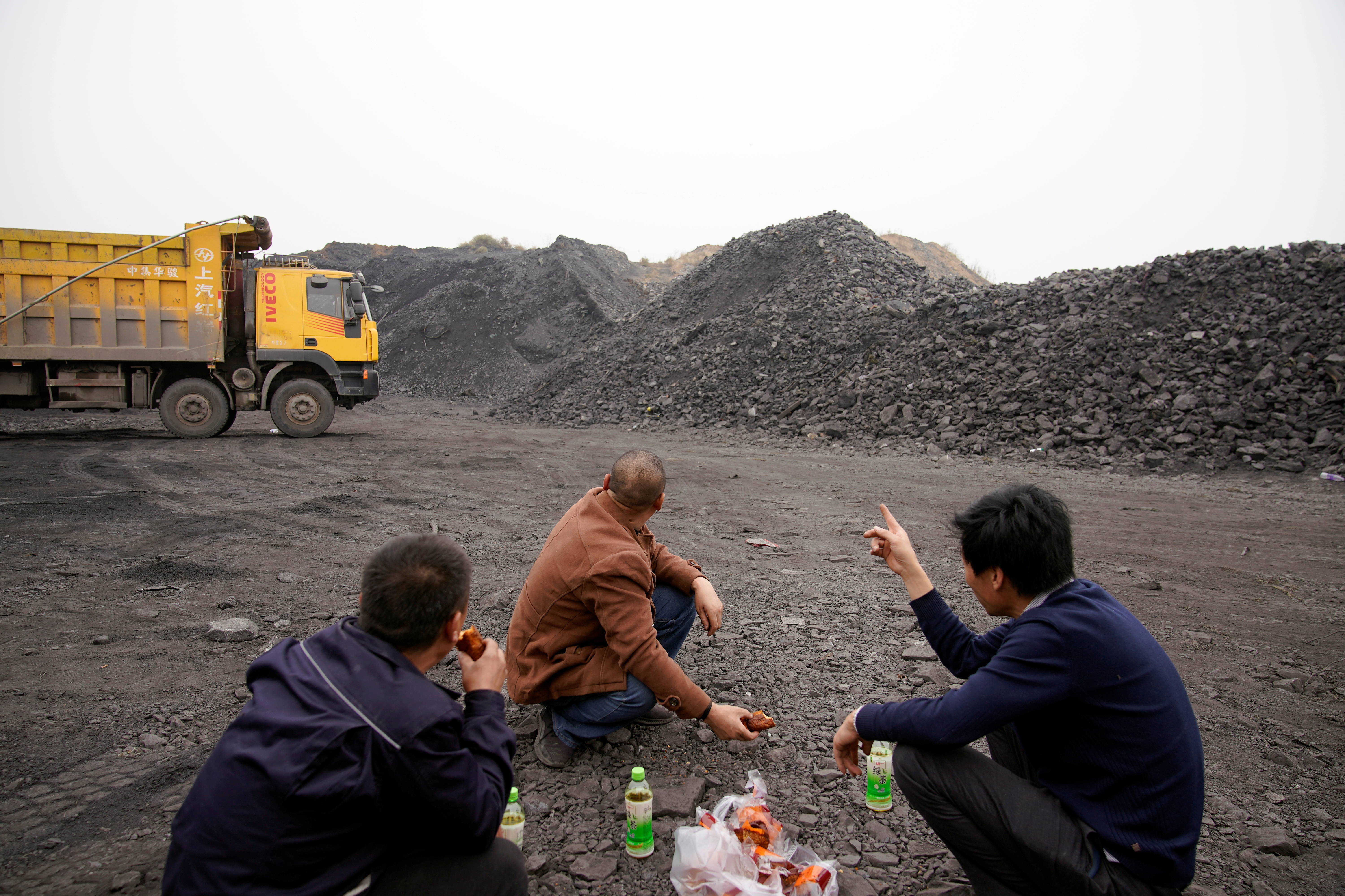 Coal truck drivers take break at lunch time in Pingdingshan