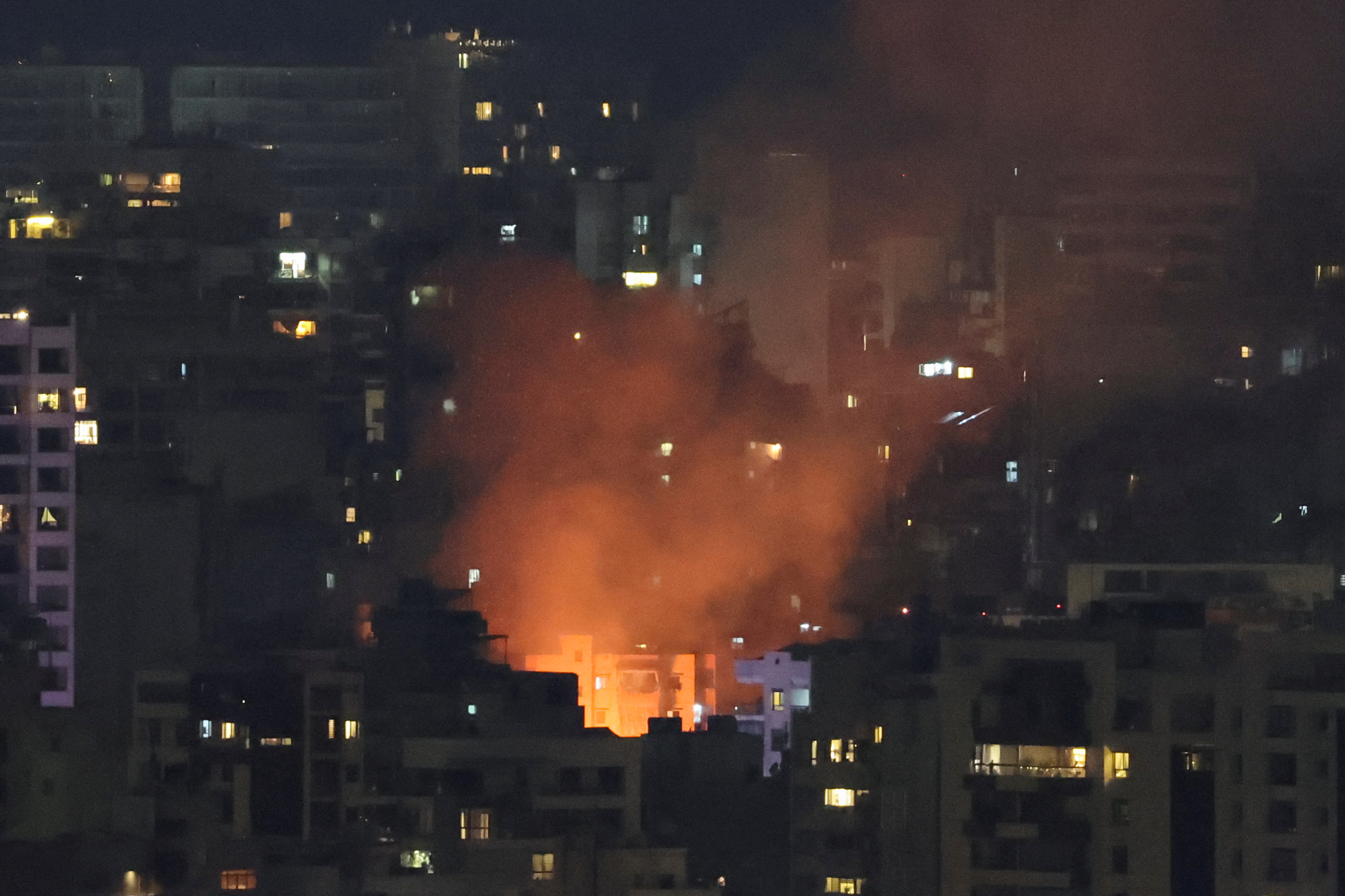 Smoke and fire rise over Beirut, after Israeli air strikes, as seen from Sin El Fil