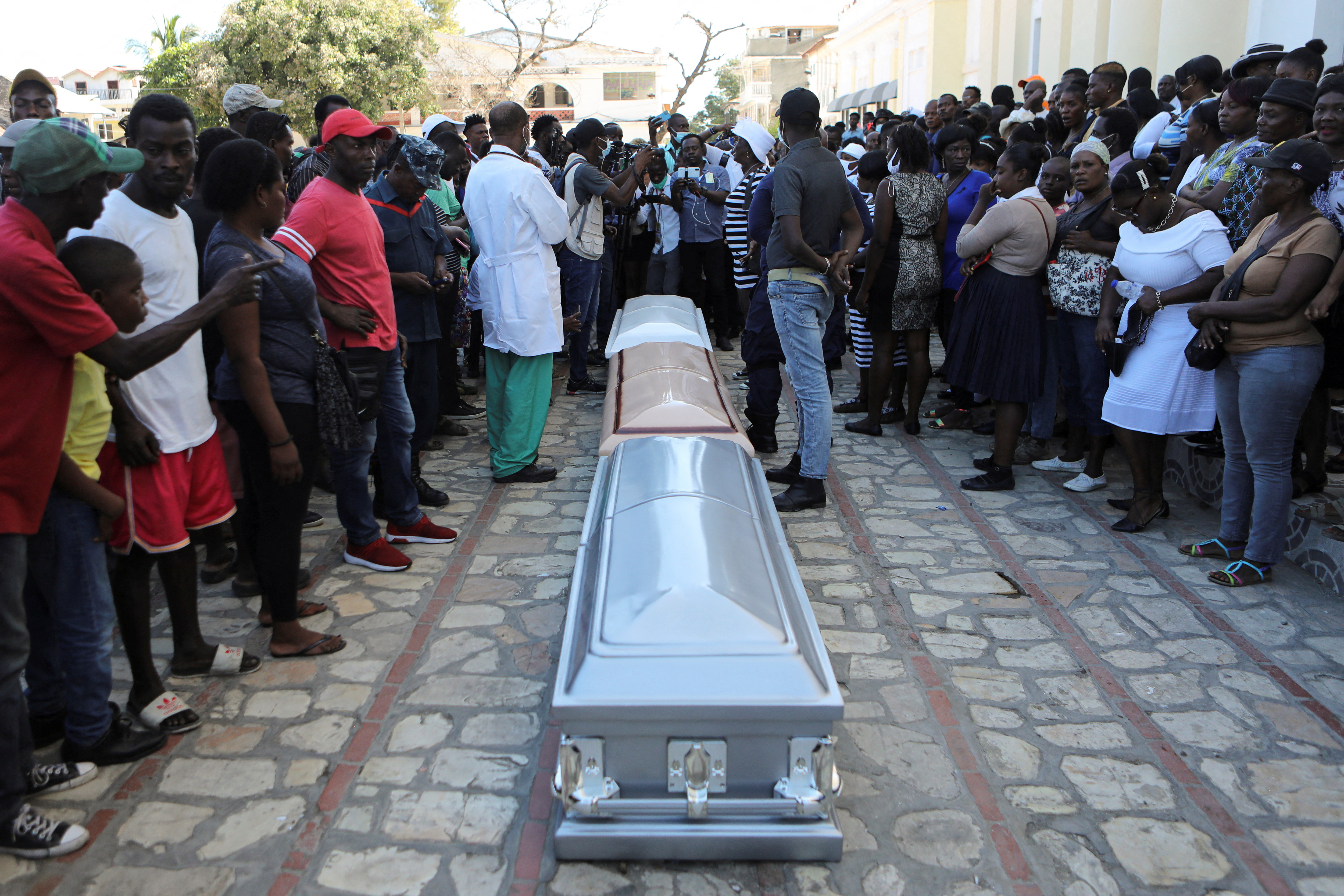 Caskets are laid in front of a church after a mass funeral service for victims of a fuel truck explosion, in Cap Haitien, Haiti December 21, 2021. REUTERS/Ralph Tedy Erol