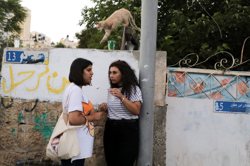 Tala, a member of the Abu Diab family, Palestinian residents of Sheikh Jarrah who face possible eviction after an Israeli court accepted Jewish settler land claims, speaks to a friend in her neighbourhood in East Jerusalem