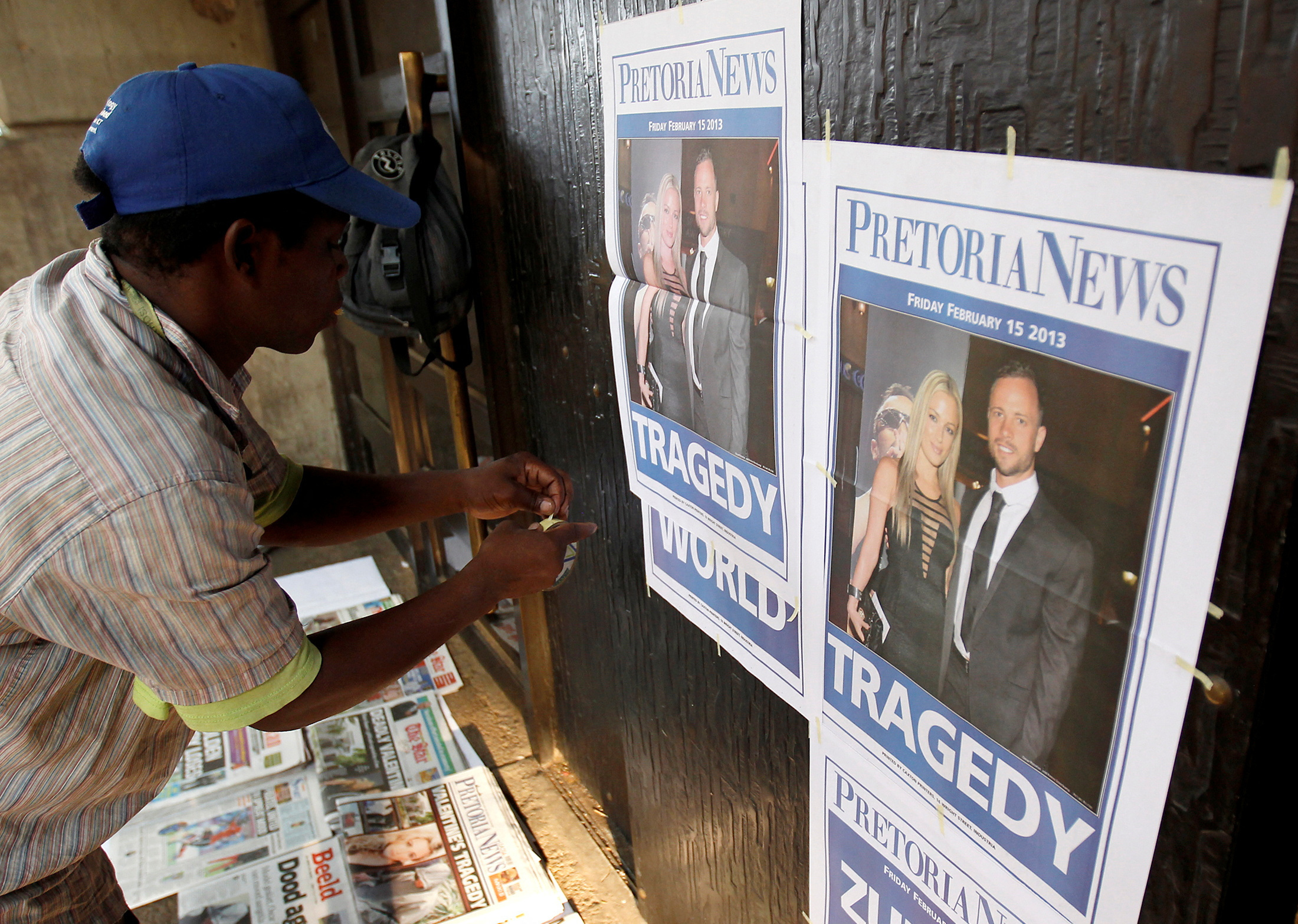 Newspaper vendor sets up his stall outside court ahead of South African 