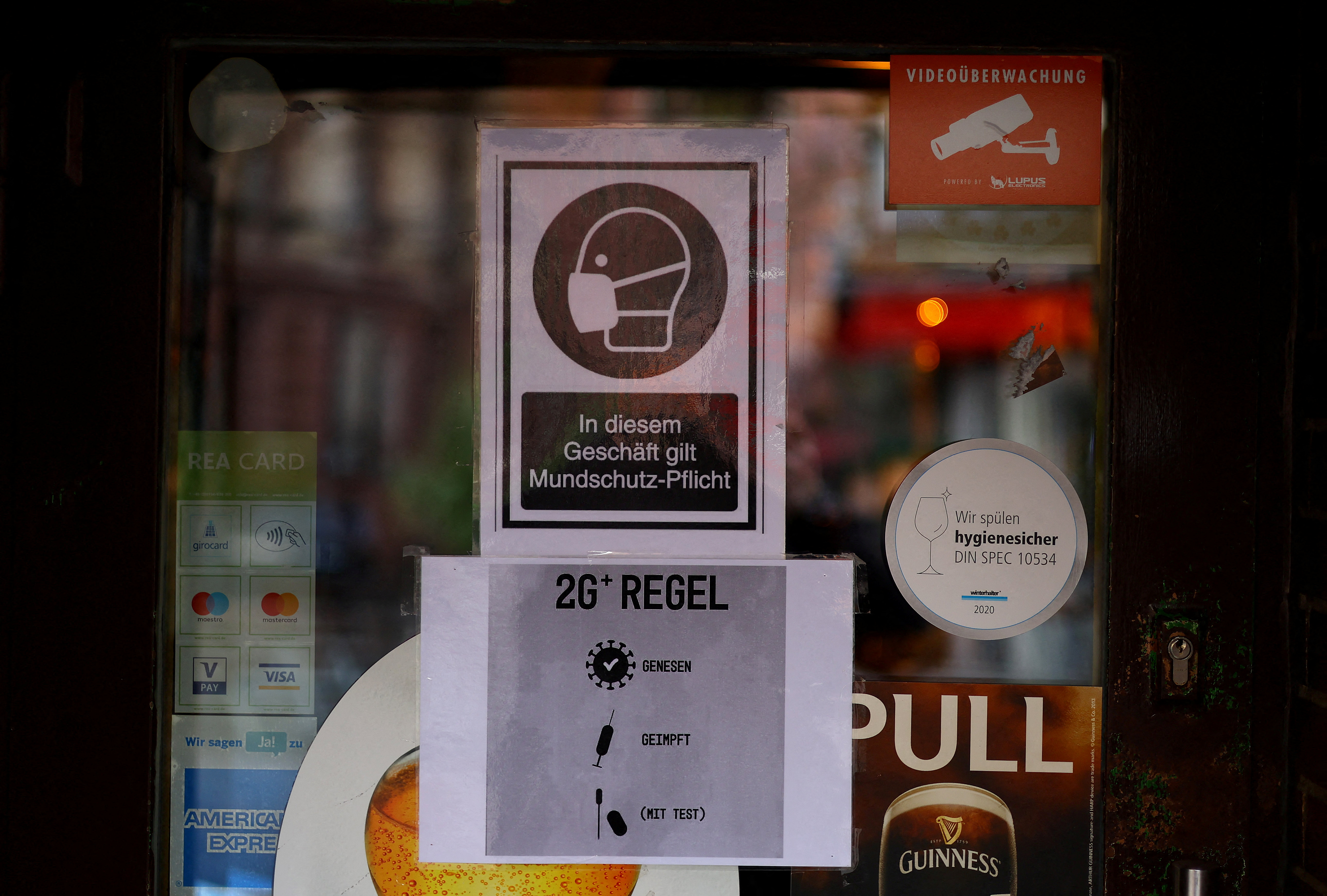 Signs show requirements to enter restaurants and bars as the spread of the coronavirus disease (Covid-19) continues in Frankfurt