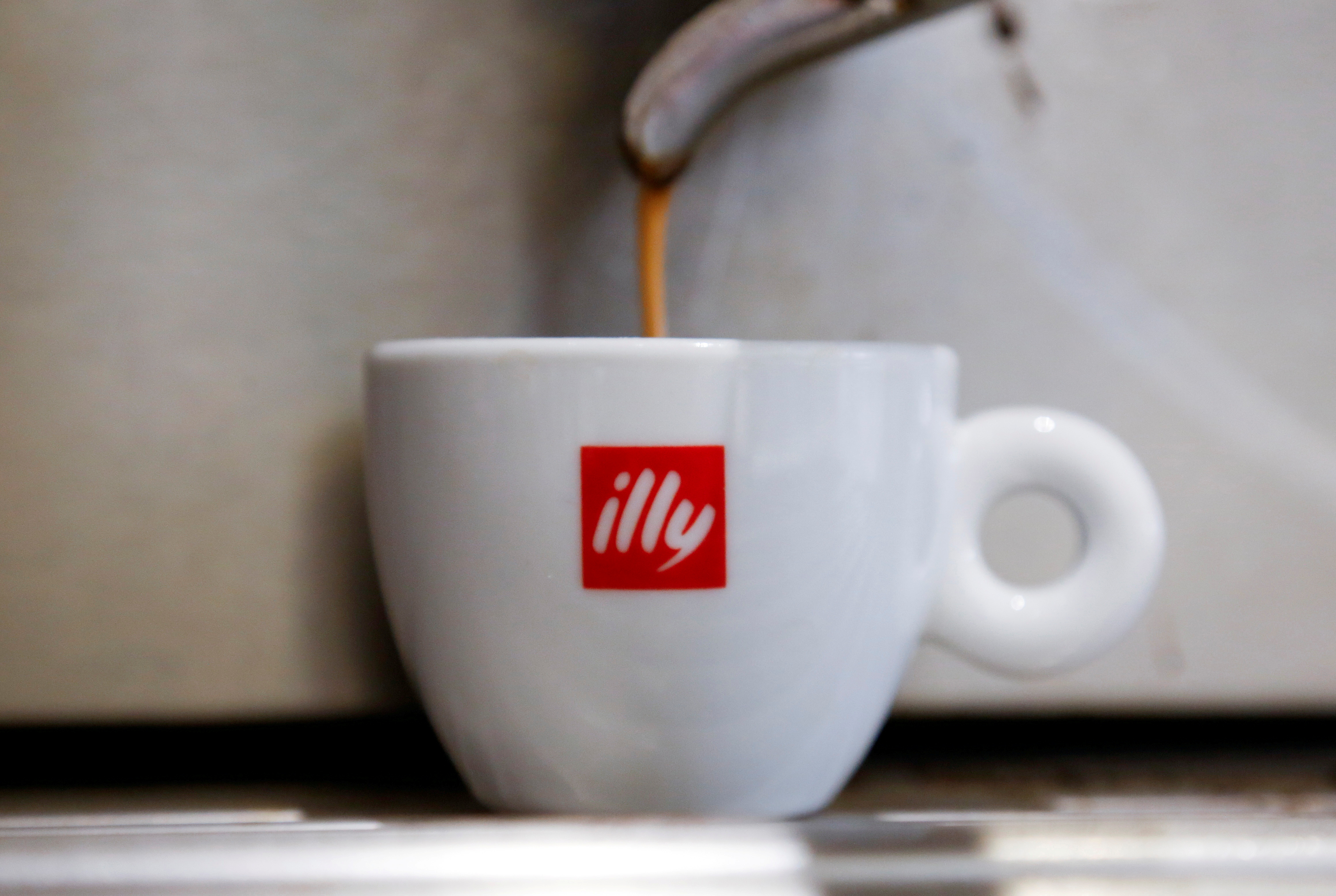 Coffee flows into a Illy cup at a coffee shop in Rome