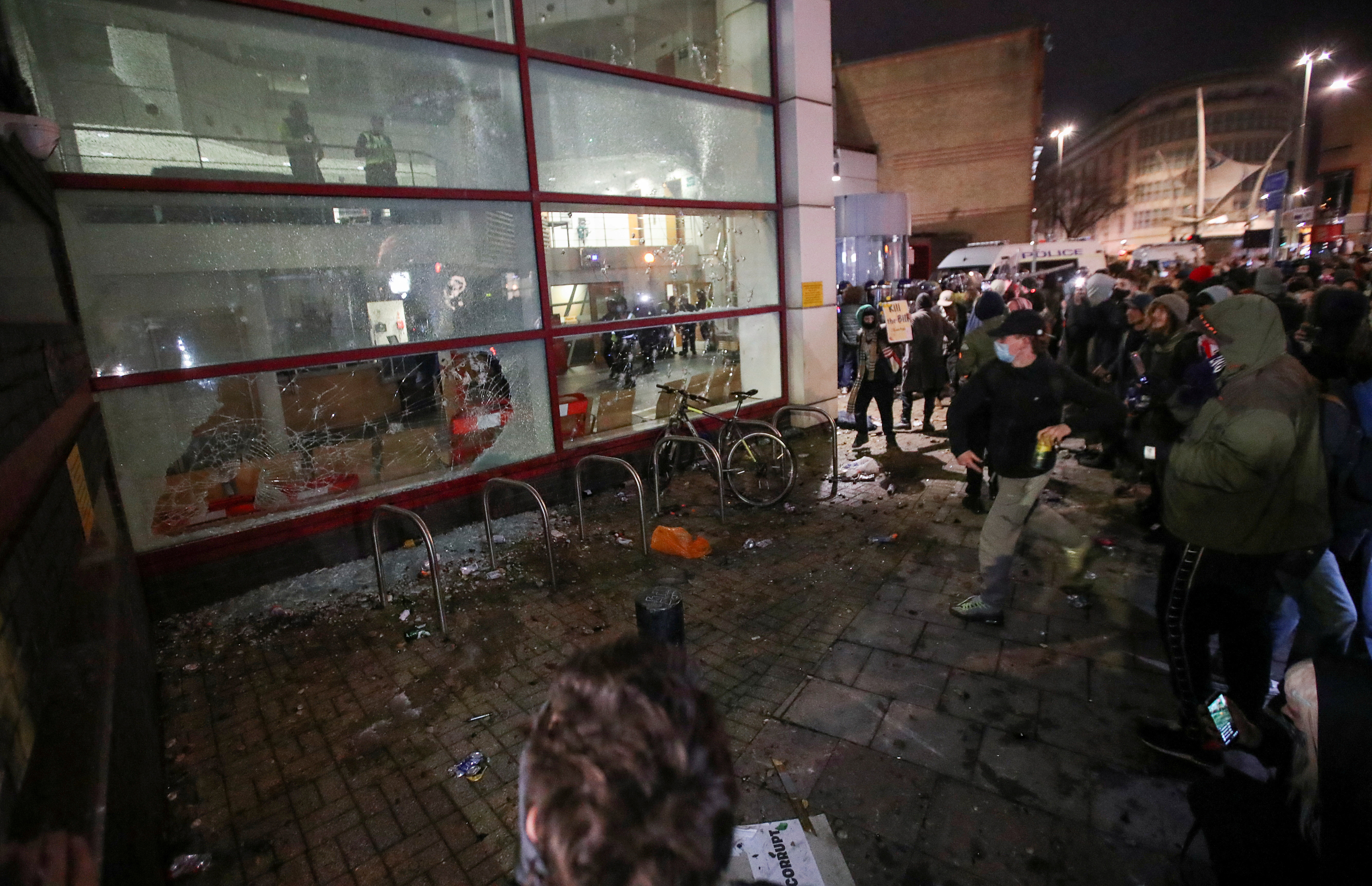 ENGLAND: Police officers hurt, vehicles set on fire in violent protest in Bristol 8 Demonstrators smash windows of a police station during a protest against a new proposed policing bill, in Bristol, Britain, March 21, 2021. REUTERS/Peter Cziborra