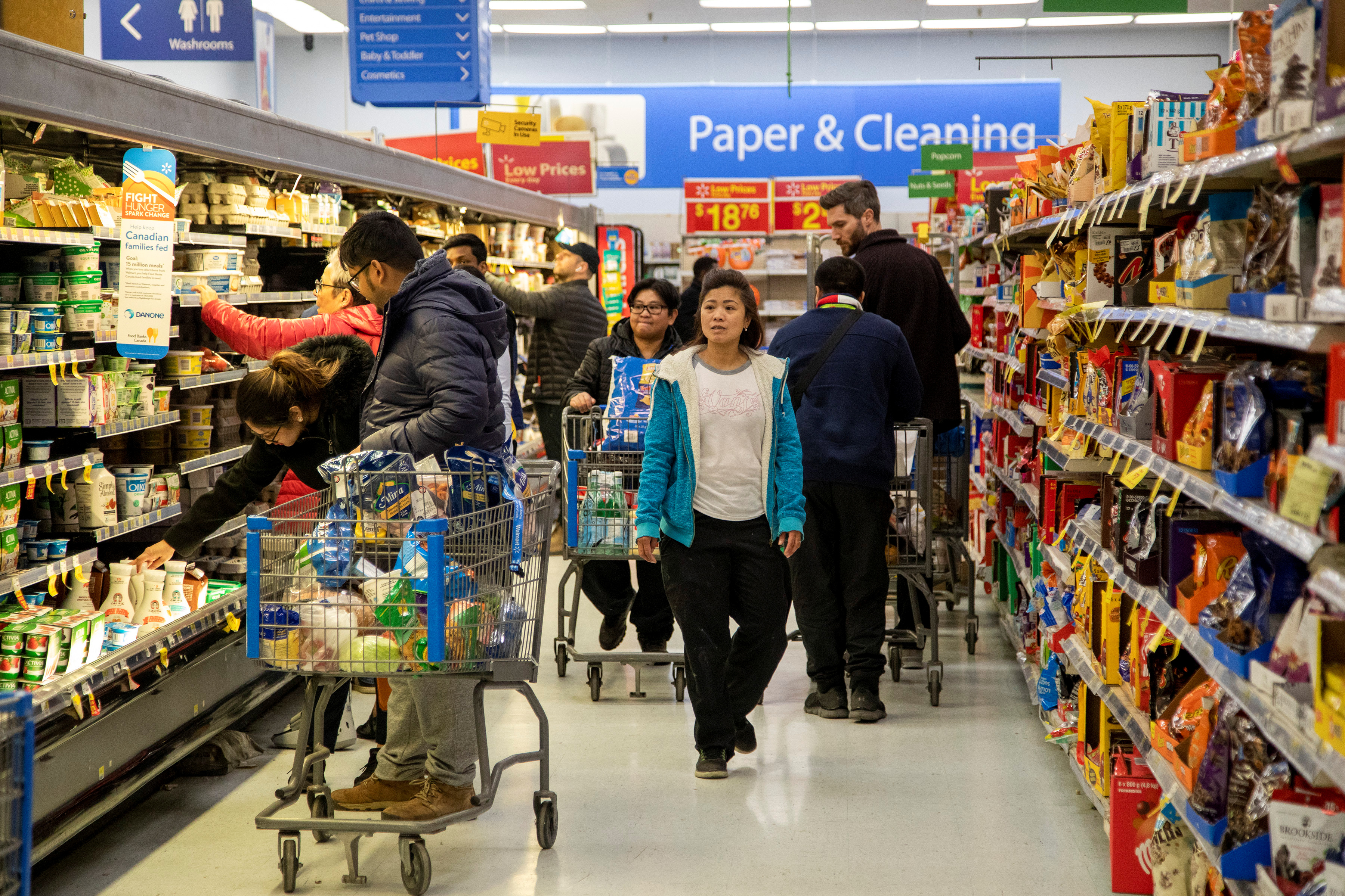 People gather supplies at a grocery store amid coronavirus fears spreading in Toronto,