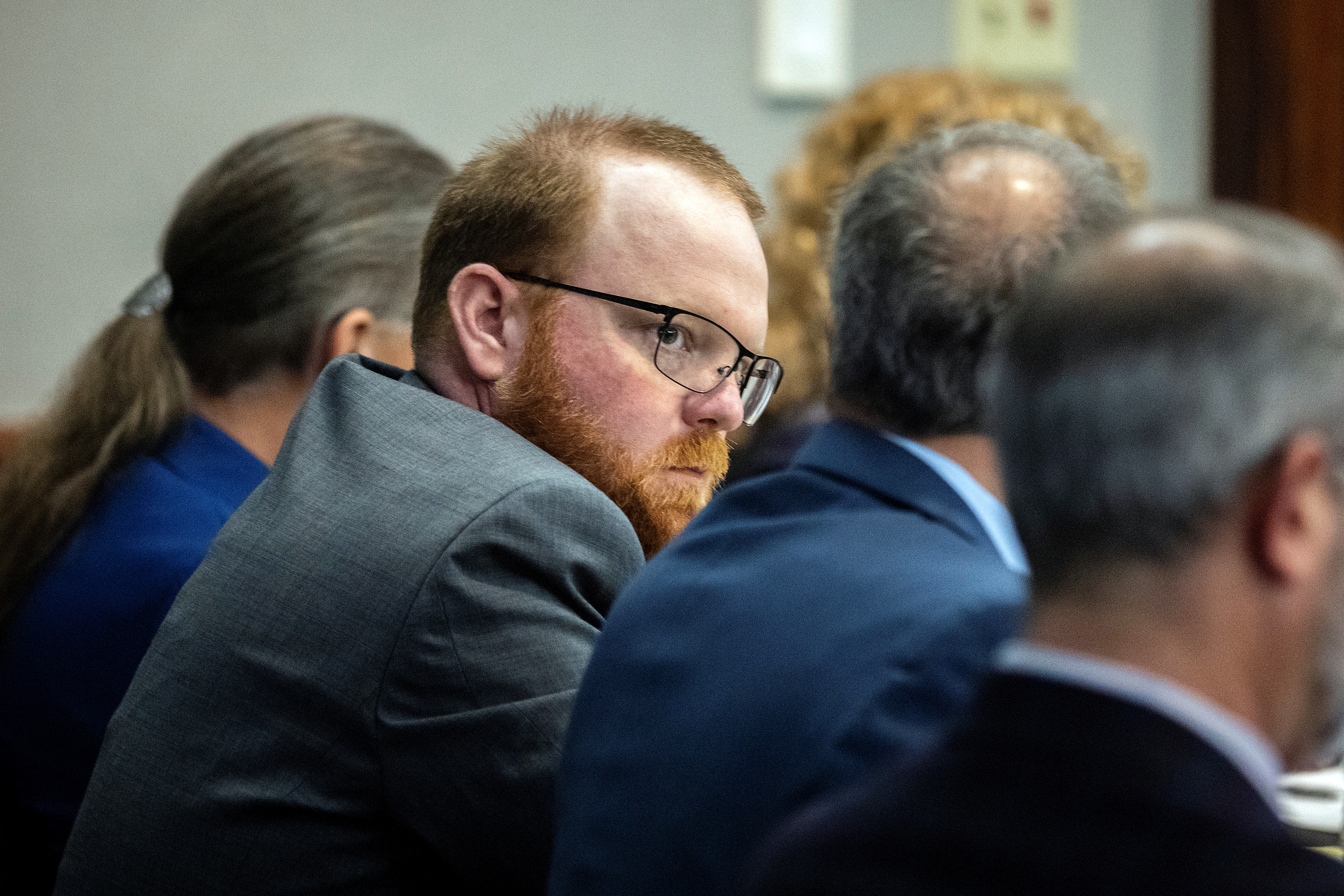 Travis McMichael sits with his attorneys before the start of closing arguments to the jury during his trial and of his father Gregory McMichael and William "Roddie" Bryan, charged with the February 2020 death of 25-year-old Ahmaud Arbery, at the Glynn County Courthouse, in Brunswick, Georgia, U.S. November 22, 2021. Stephen B. Morton/Pool via REUTERS