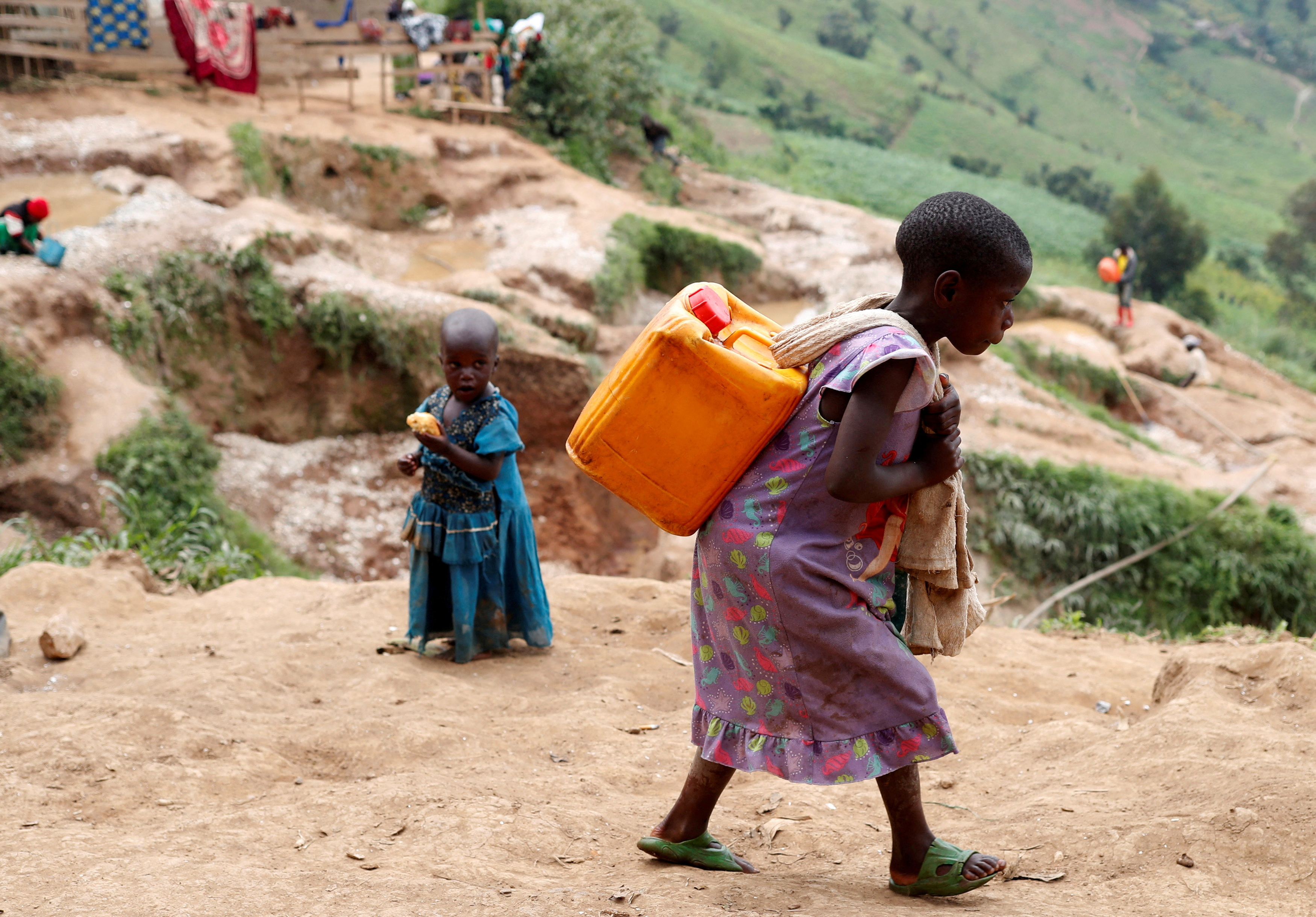 A girl carries a container of water at a coltan mine in Kamatare, Masisi territory, North Kivu Province of Democratic Republic of Congo