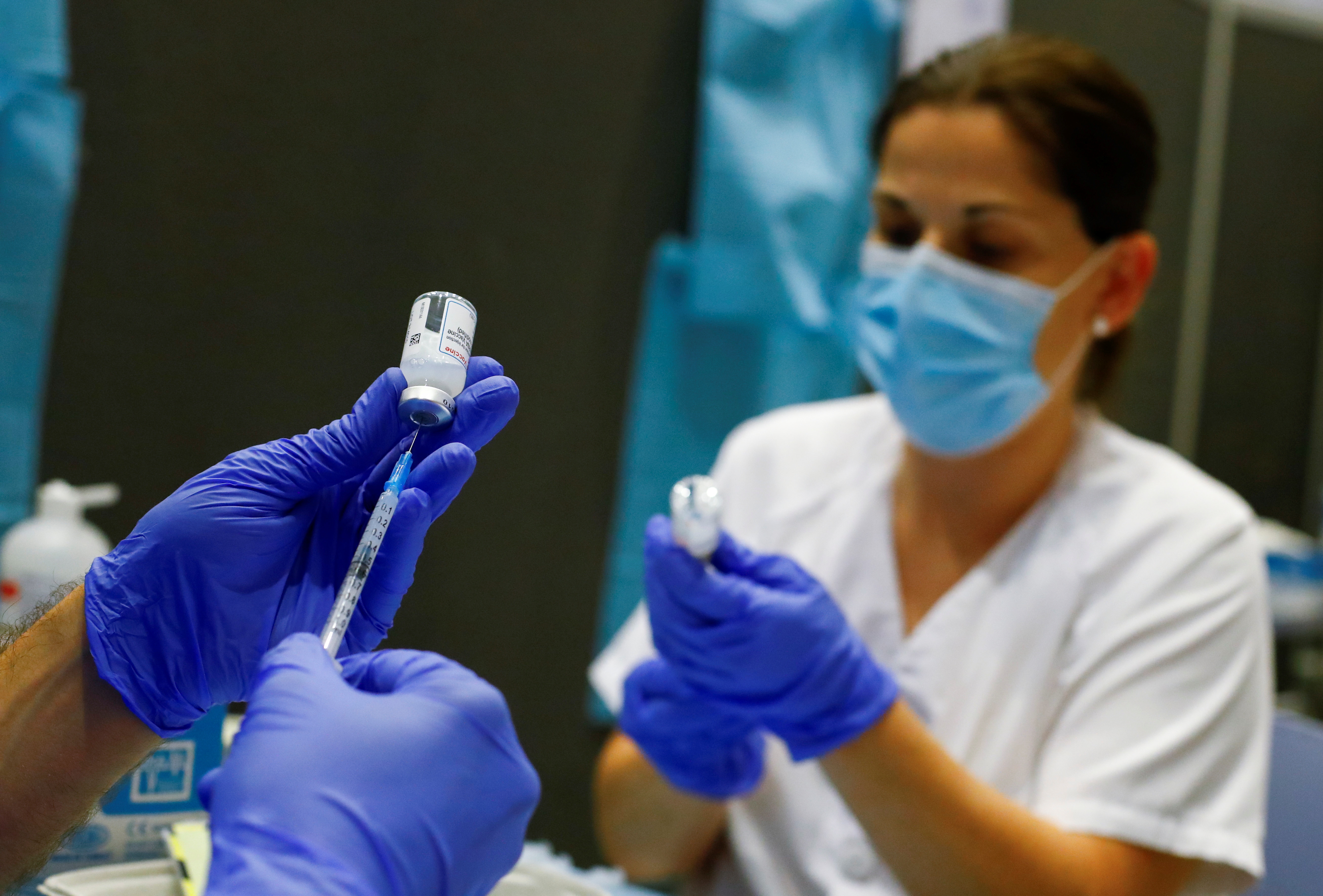 Nurses prepare syringes with doses of the Moderna vaccine against the coronavirus disease (COVID-19) at a vaccination centre in Meloneras on the island of Gran Canaria, Spain, July 28, 2021. REUTERS/Borja Suarez