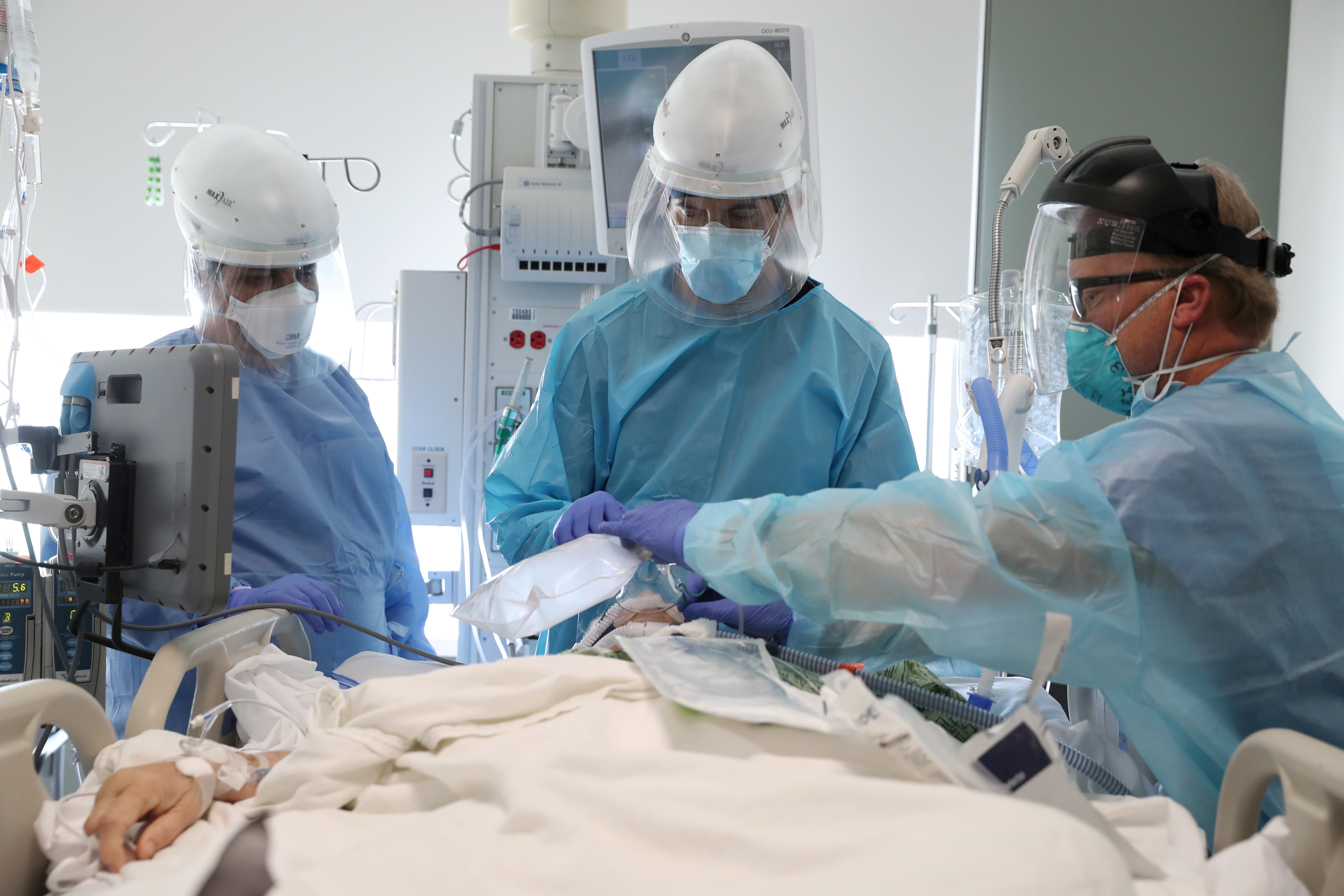 Dr. Dan Ponticiello, 43, and Dr. Gabriel Gomez, 40, intubate a coronavirus disease (COVID-19) patient in the COVID-19 ICU at Providence Mission Hospital in Mission Viejo
