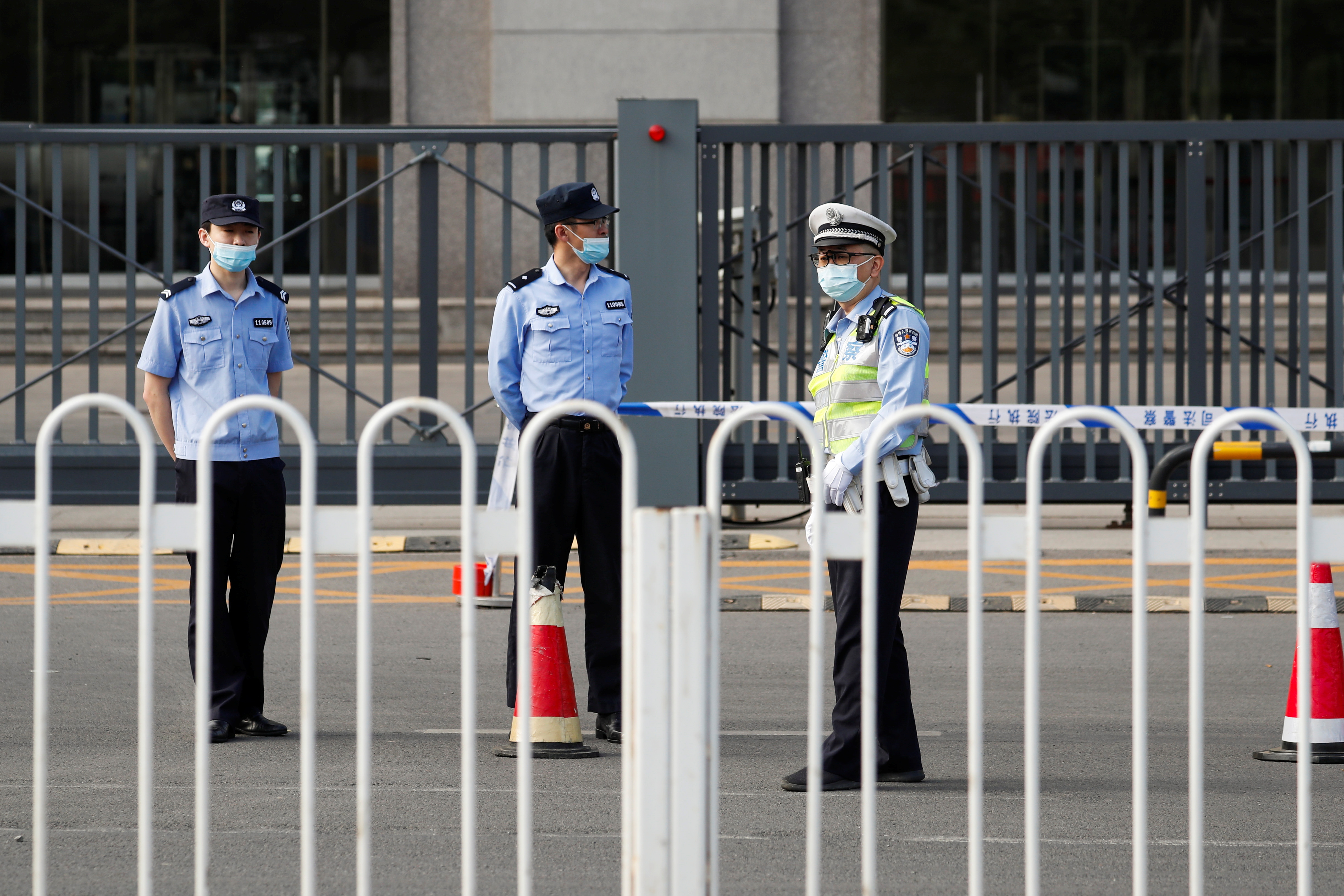 Police officers stand guard outside Beijing No. 2 Intermediate People's Court where Australian writer Yang Hengjun is expected to face trial on espionage charges, in Beijing