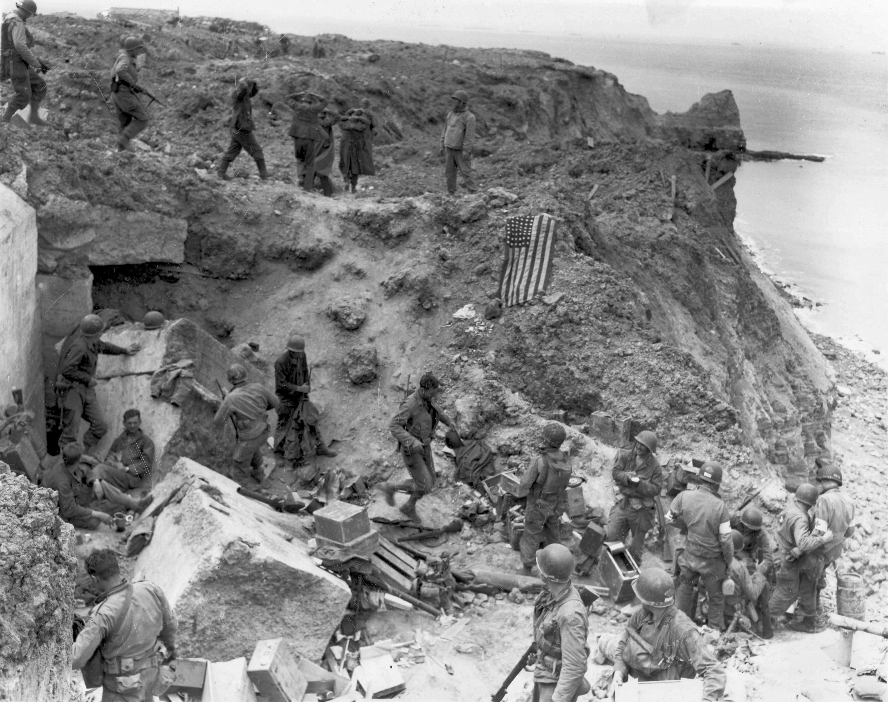 Handout photo of a U.S. flag used as a marker on a destroyed bunker at Pointe du Hoc