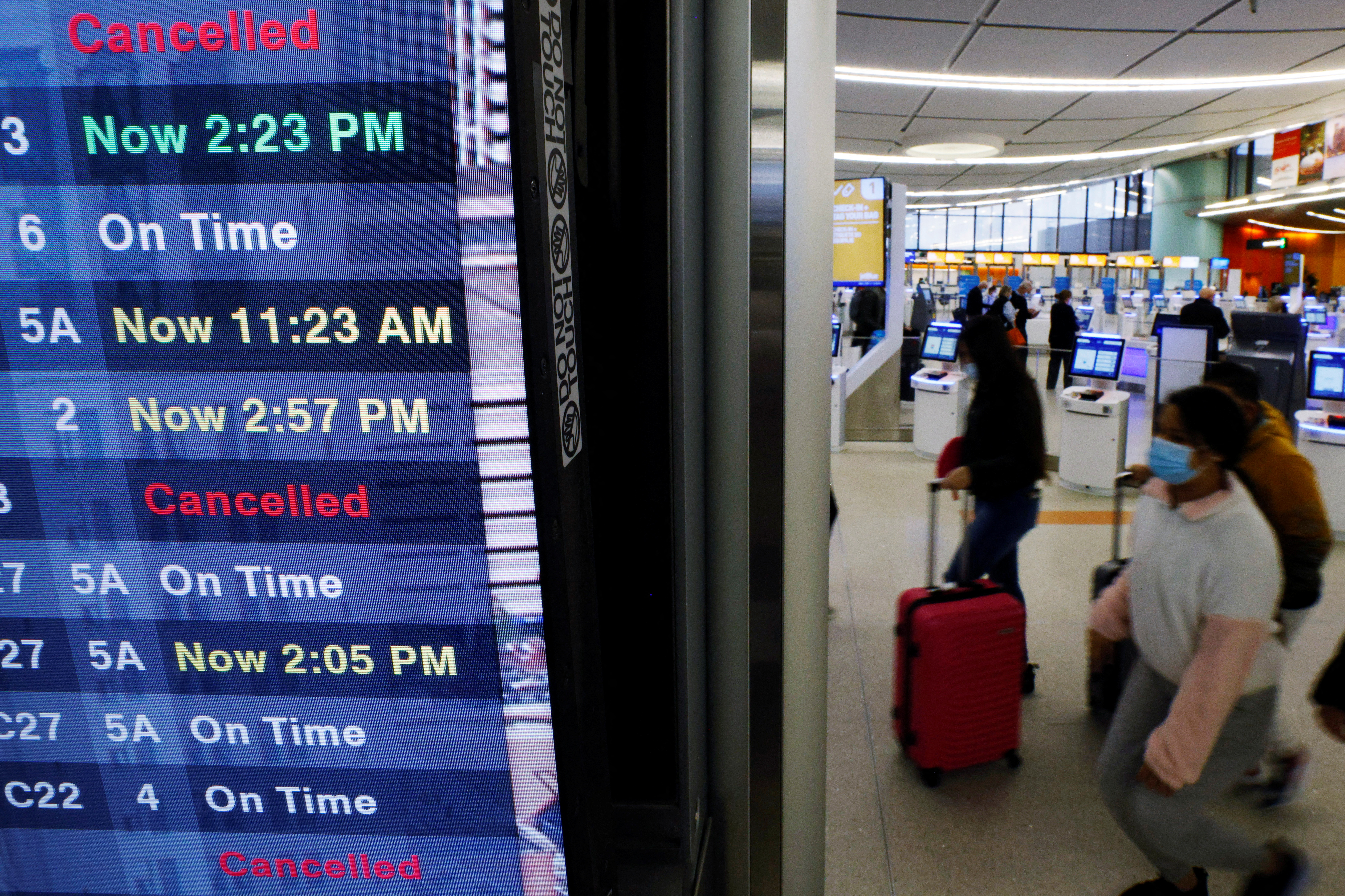 A board displays the status of flights to and from Logan International Airport in Boston