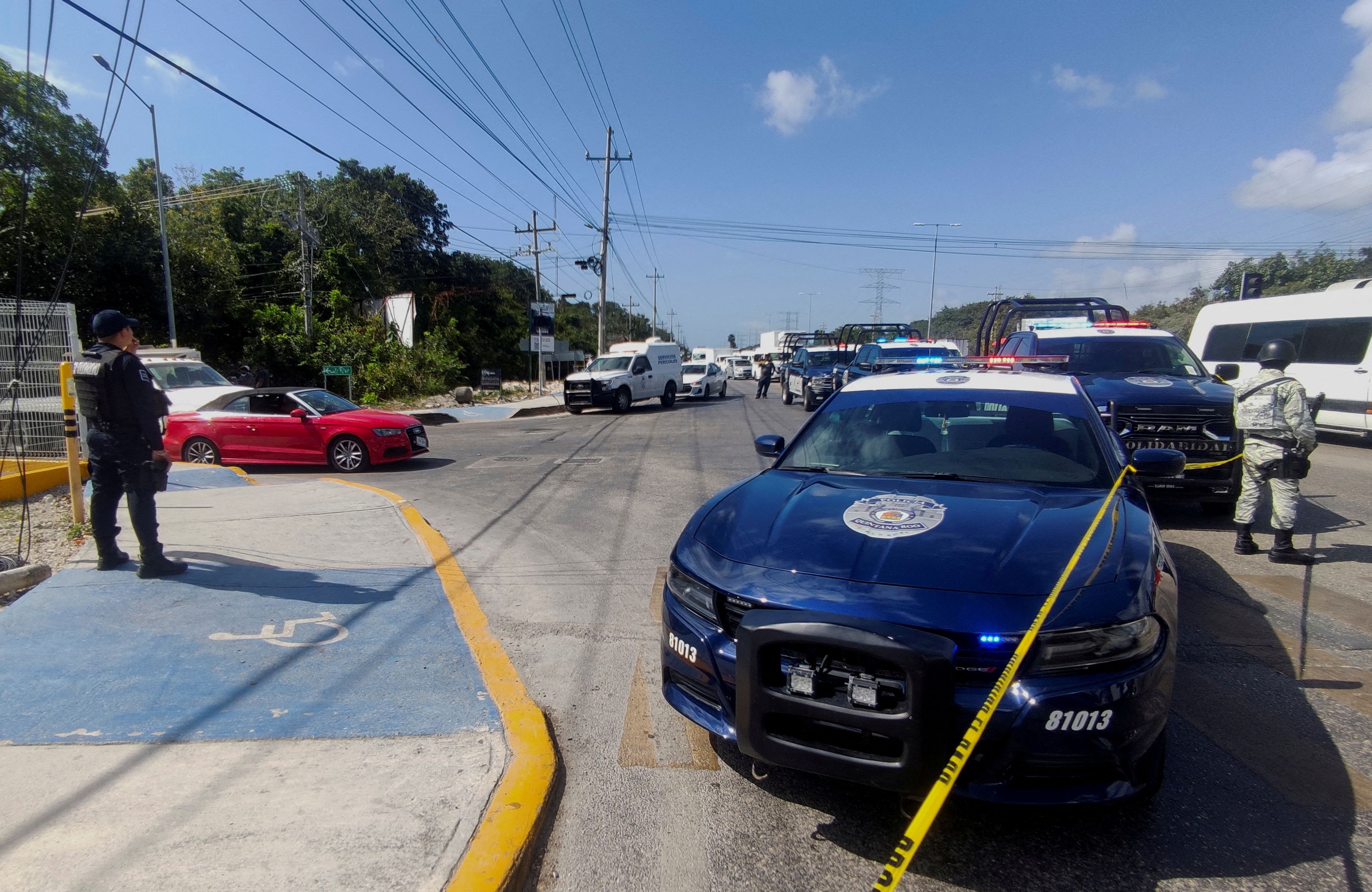 Members of security forces stand guard near the crime scene where the British businessman Chris Cleave, 54, was killed by a gunmen, according to local media, in Playa del Carmen