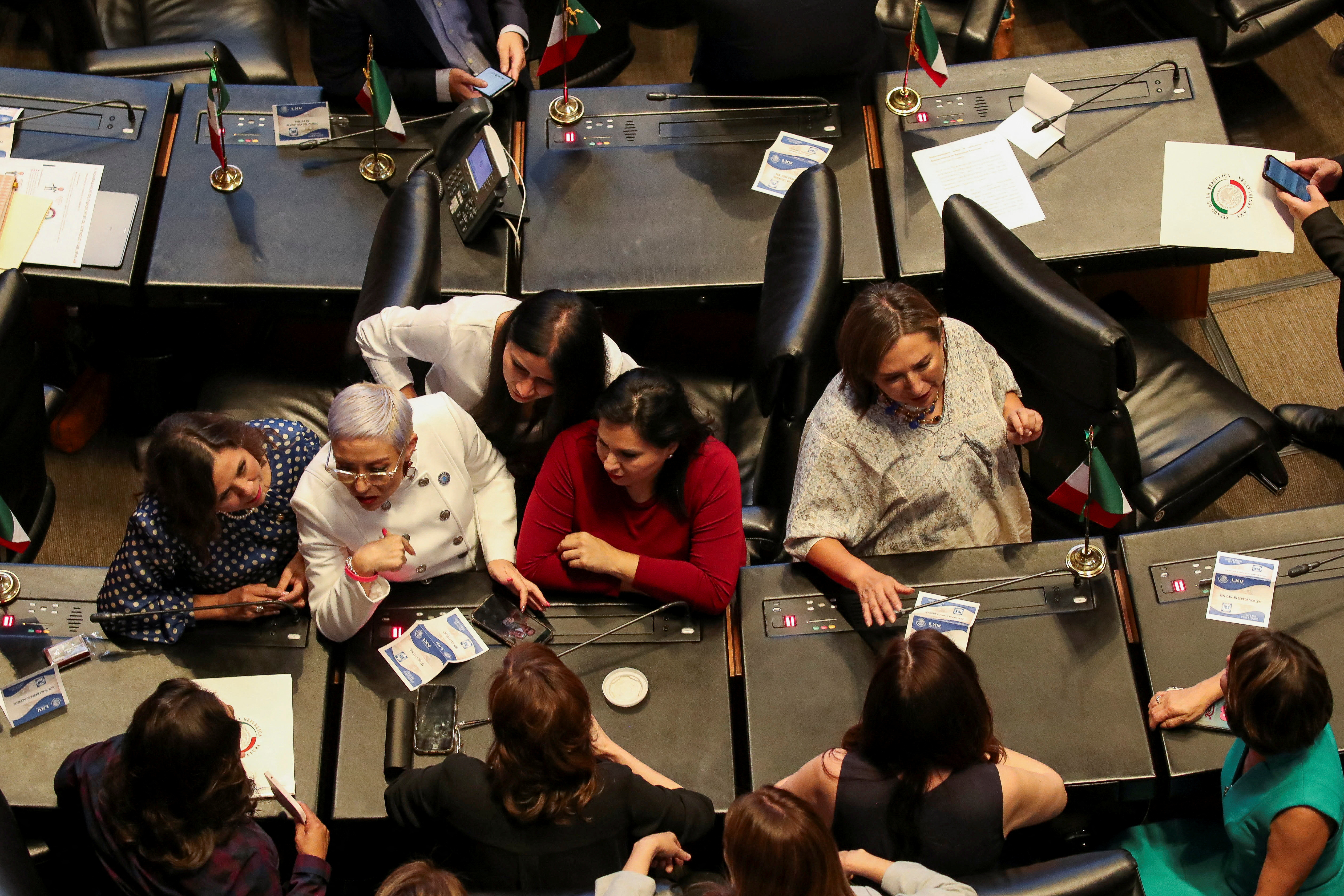 Senators of the National Action Party (PAN) chat during a session at the Senate, in Mexico City