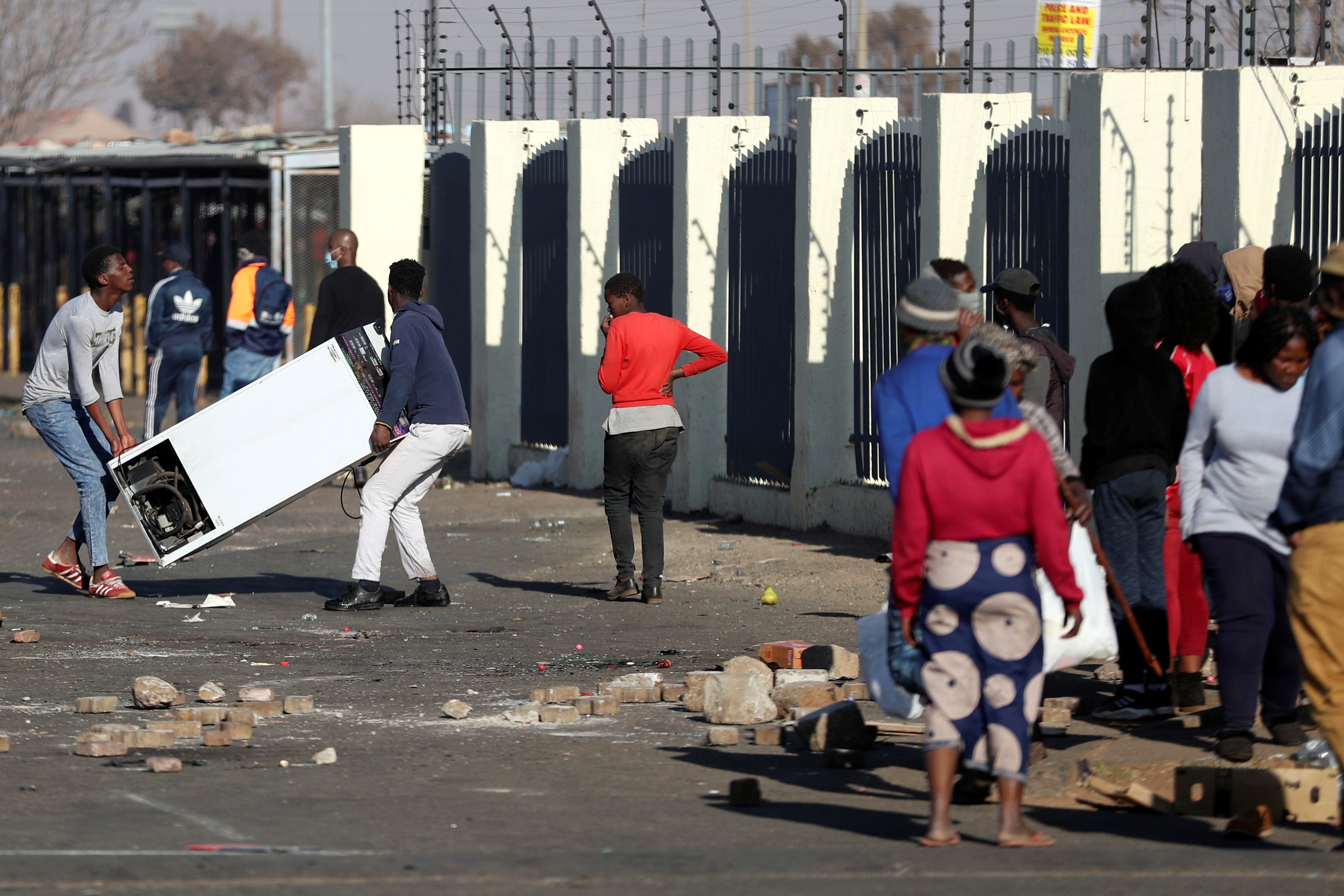 Demonstrators loot a shopping centre during protests following the imprisonment of former South Africa President Jacob Zuma, in Katlehong, South Africa, July 12, 2021. REUTERS/Siphiwe Sibeko