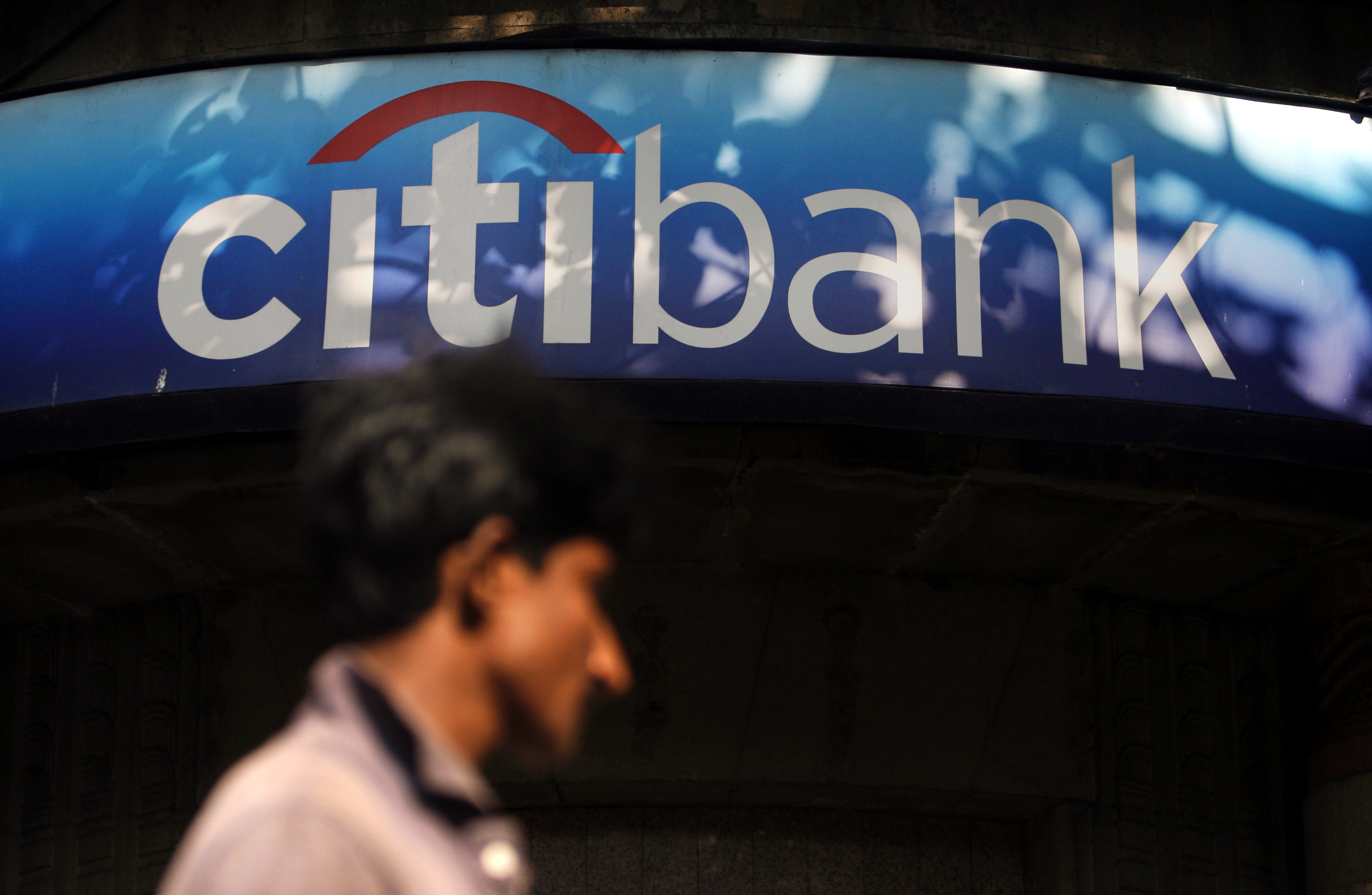A man walks in front of a Citibank branch in Mumbai