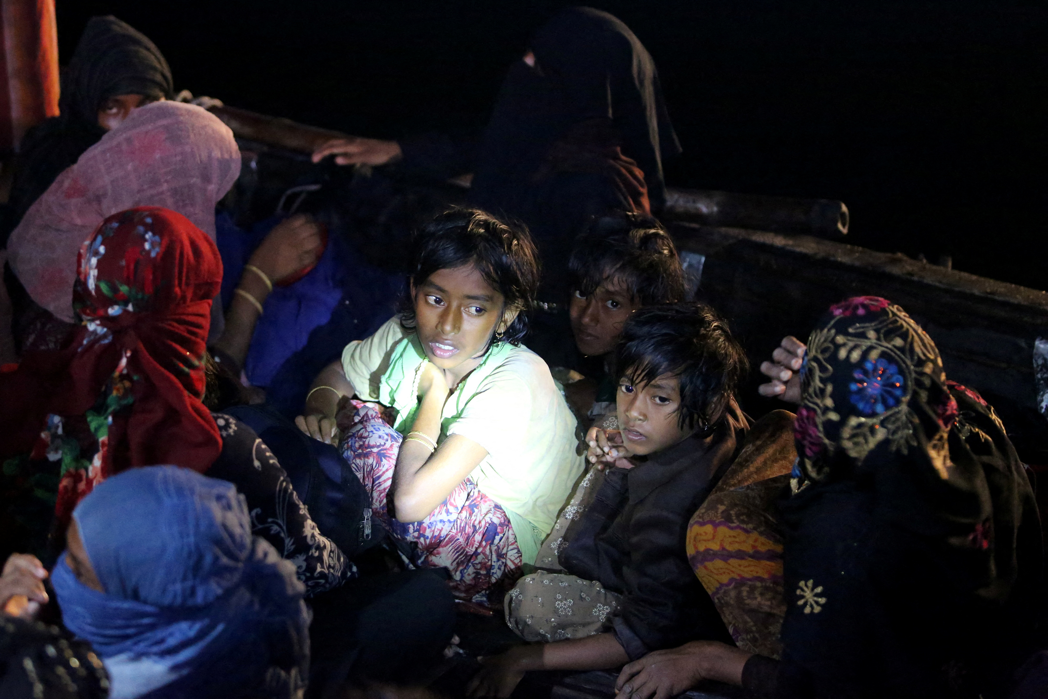 Rohingya children are seen on a boat waiting for evacuation as they arrive at a port in Krueng Geukuh near Lhokseumawe, North Aceh