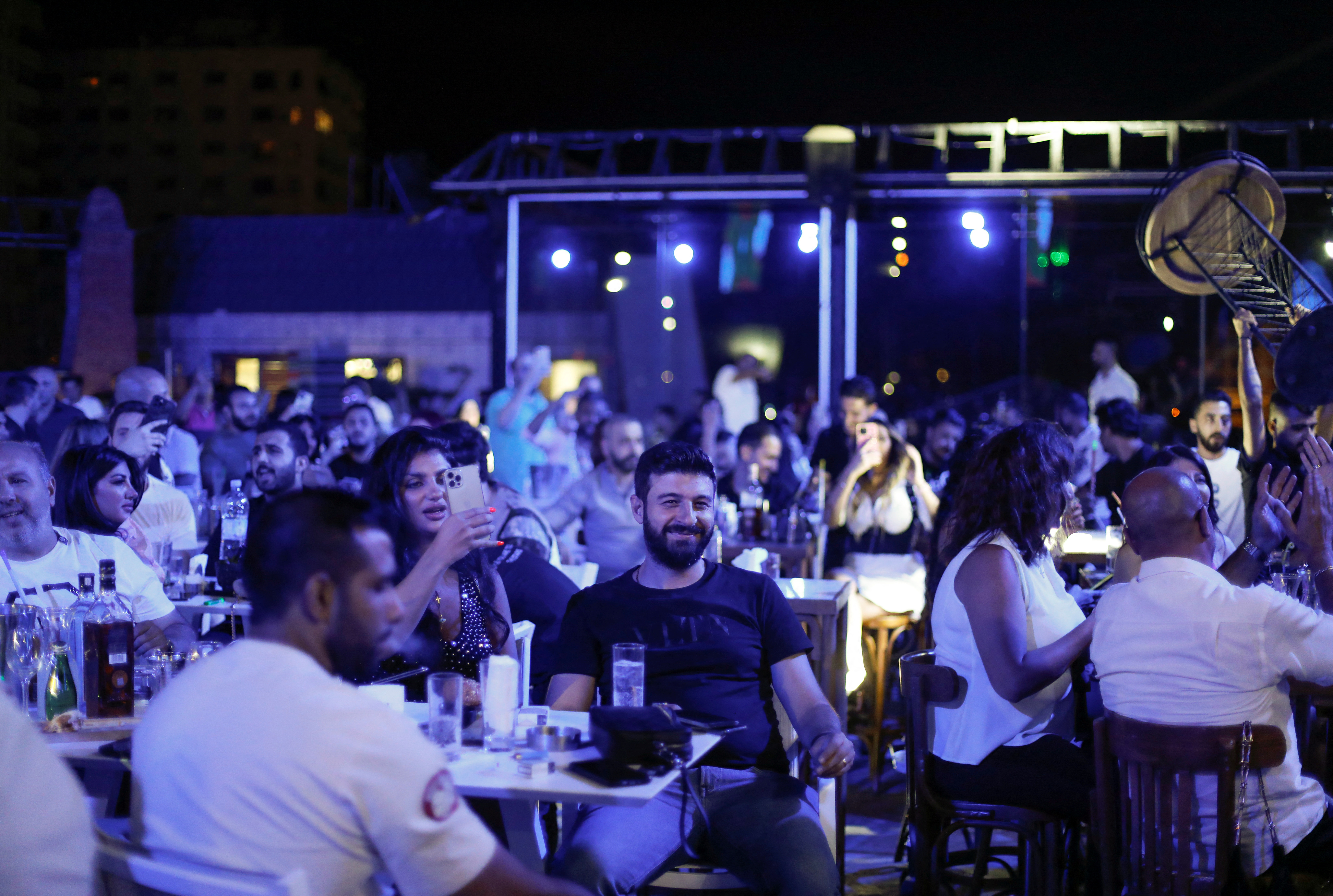 People sit at a rooftop lounge in Damascus
