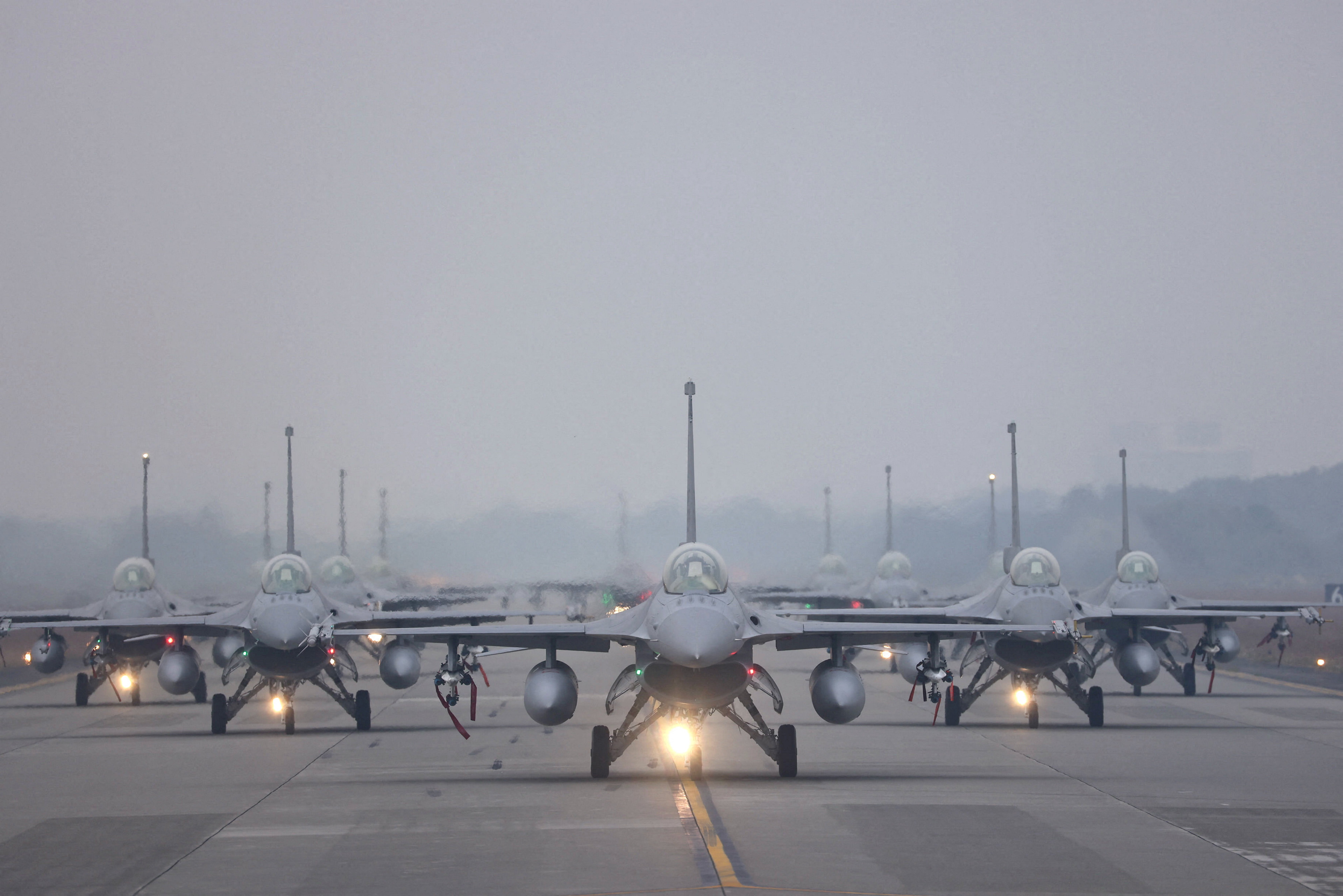 12 F-16V fighter jets perform an elephant walk during an annual New Year's drill in Chiayi
