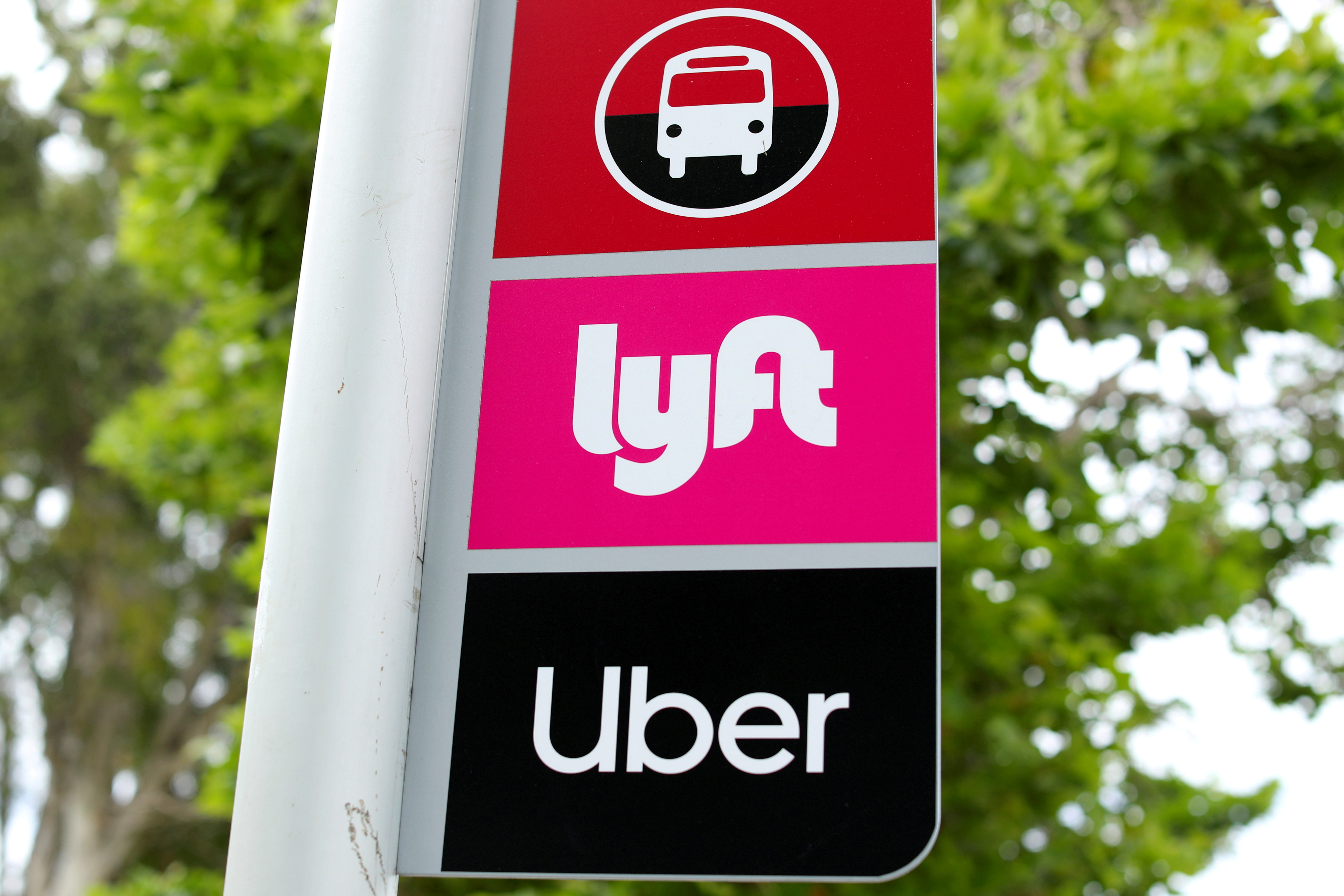 A sign marks a rendezvous location for Lyft and Uber users at San Diego State University in San Diego, California, U.S., May 13, 2020.      REUTERS/Mike Blake/File Photo
