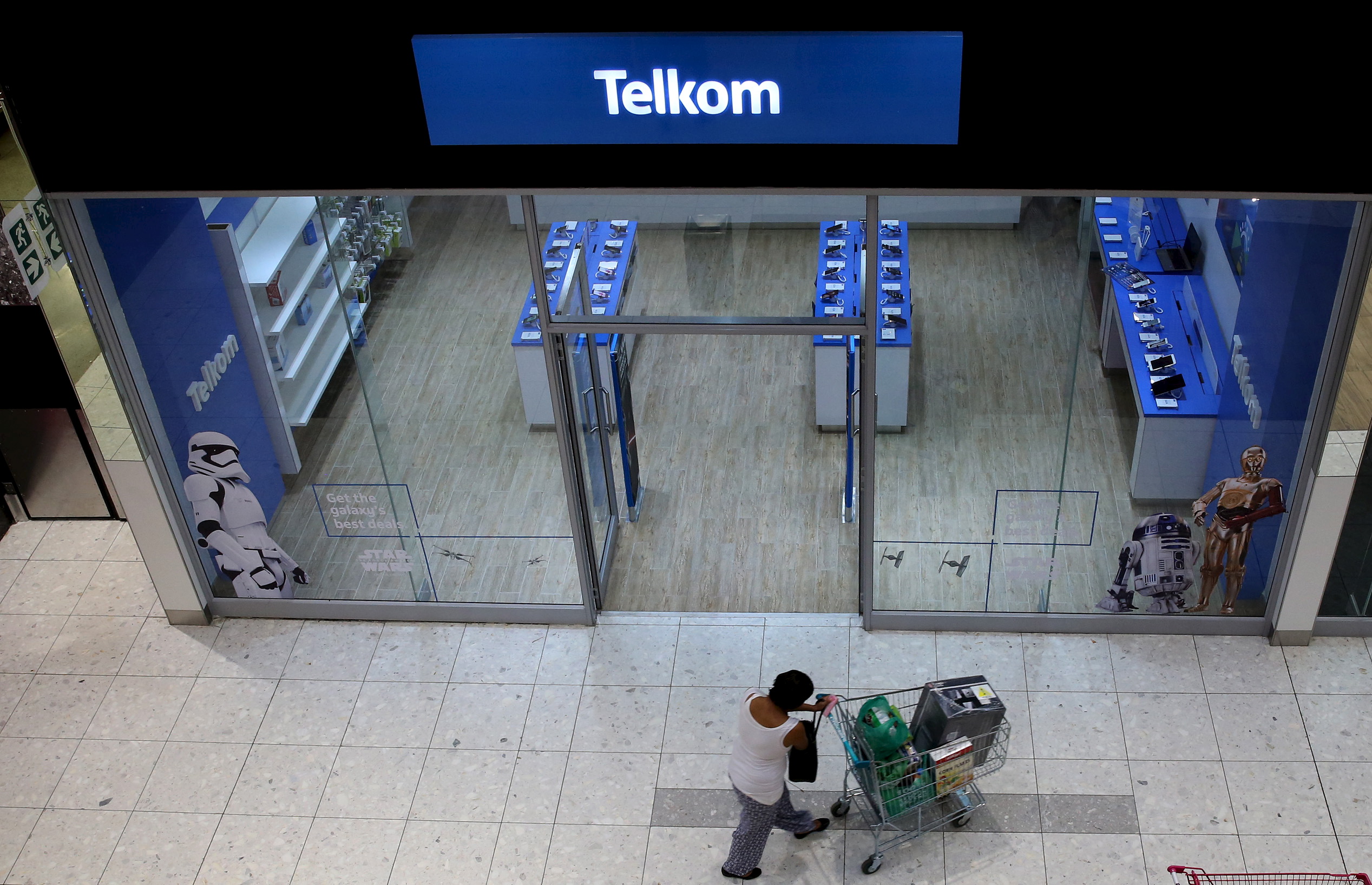 A shopper walks past a Telkom shop at a mall in Johannesburg