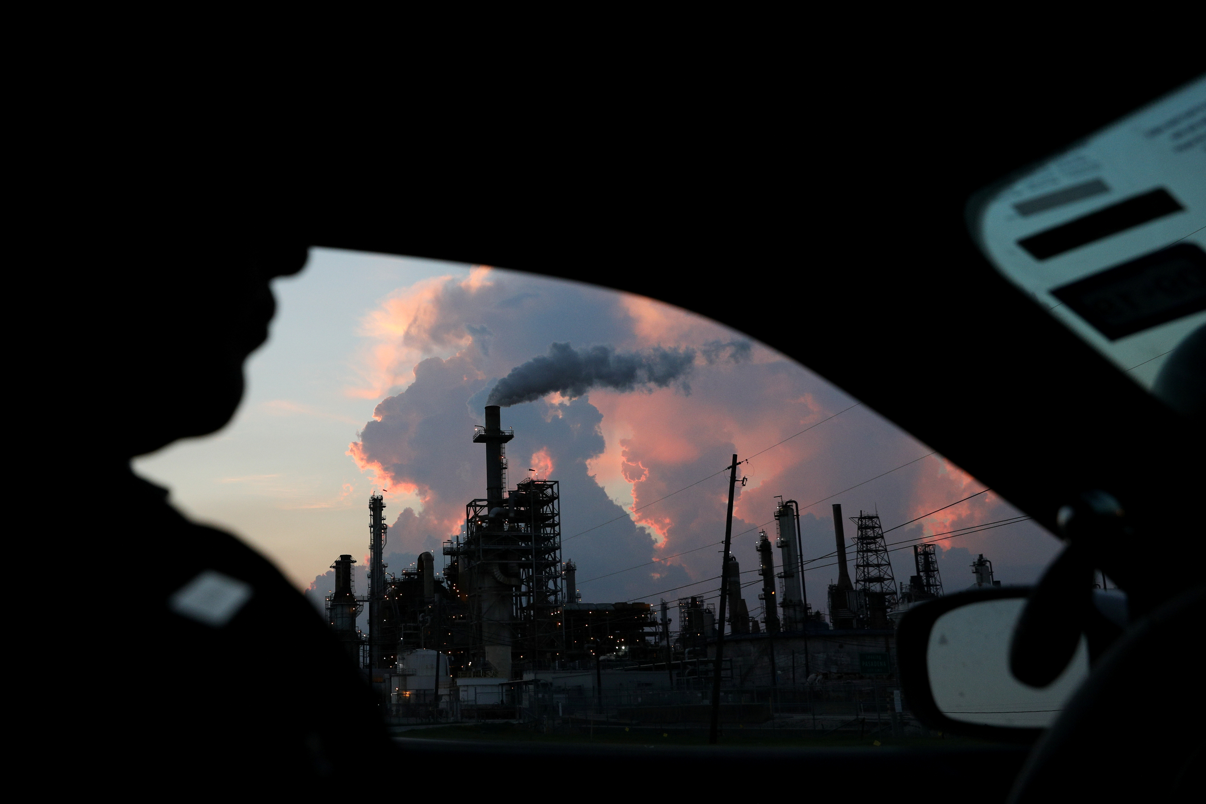 A police officer drives past a refinery in the industrial east end in Pasadena, Texas, U.S., September 18, 2018. REUTERS/Loren Elliott