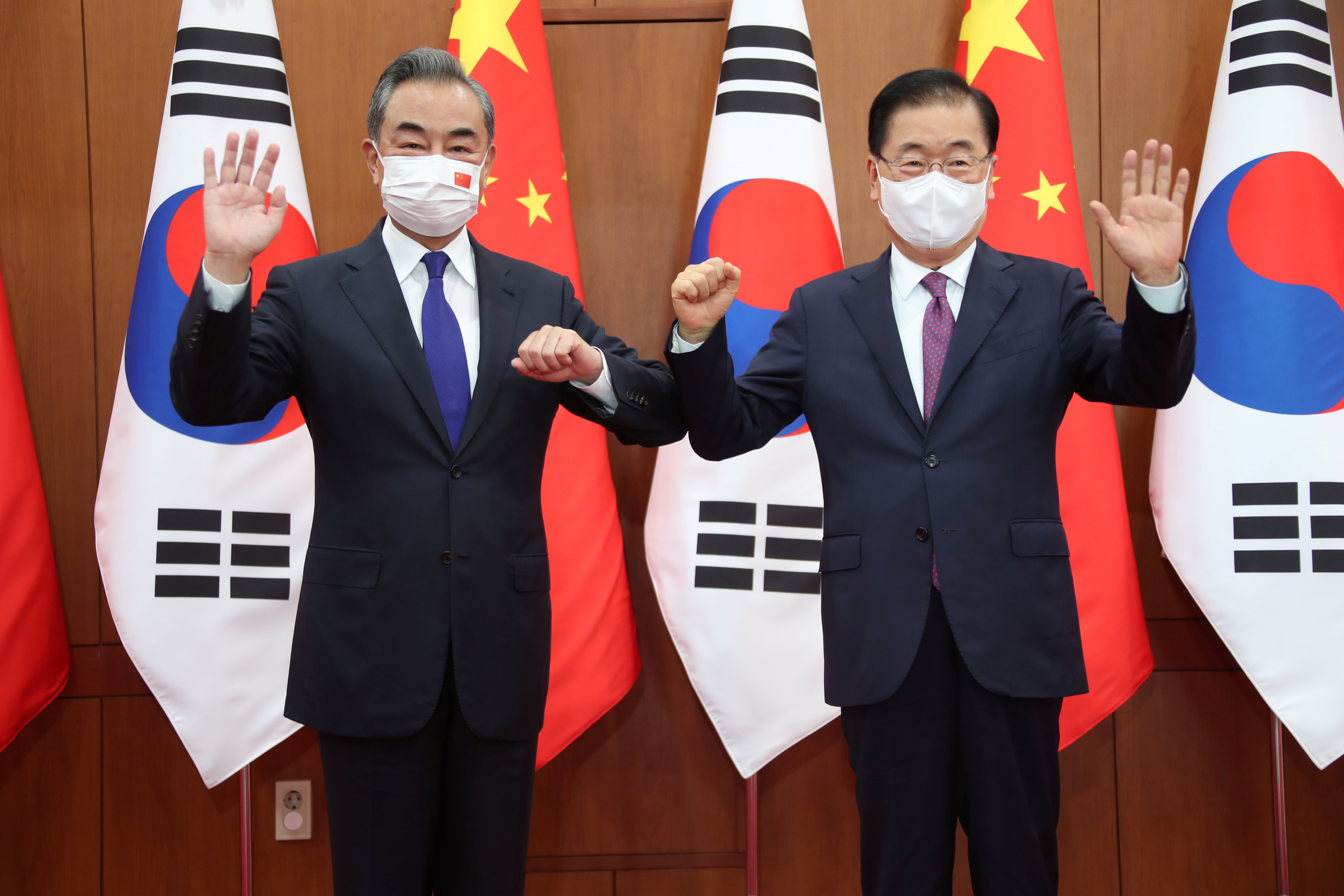 Chinese Foreign Minister Wang Yi poses for photographs with his South Korean counterpart Chung Eui-yong at Foreign Ministry in Seoul