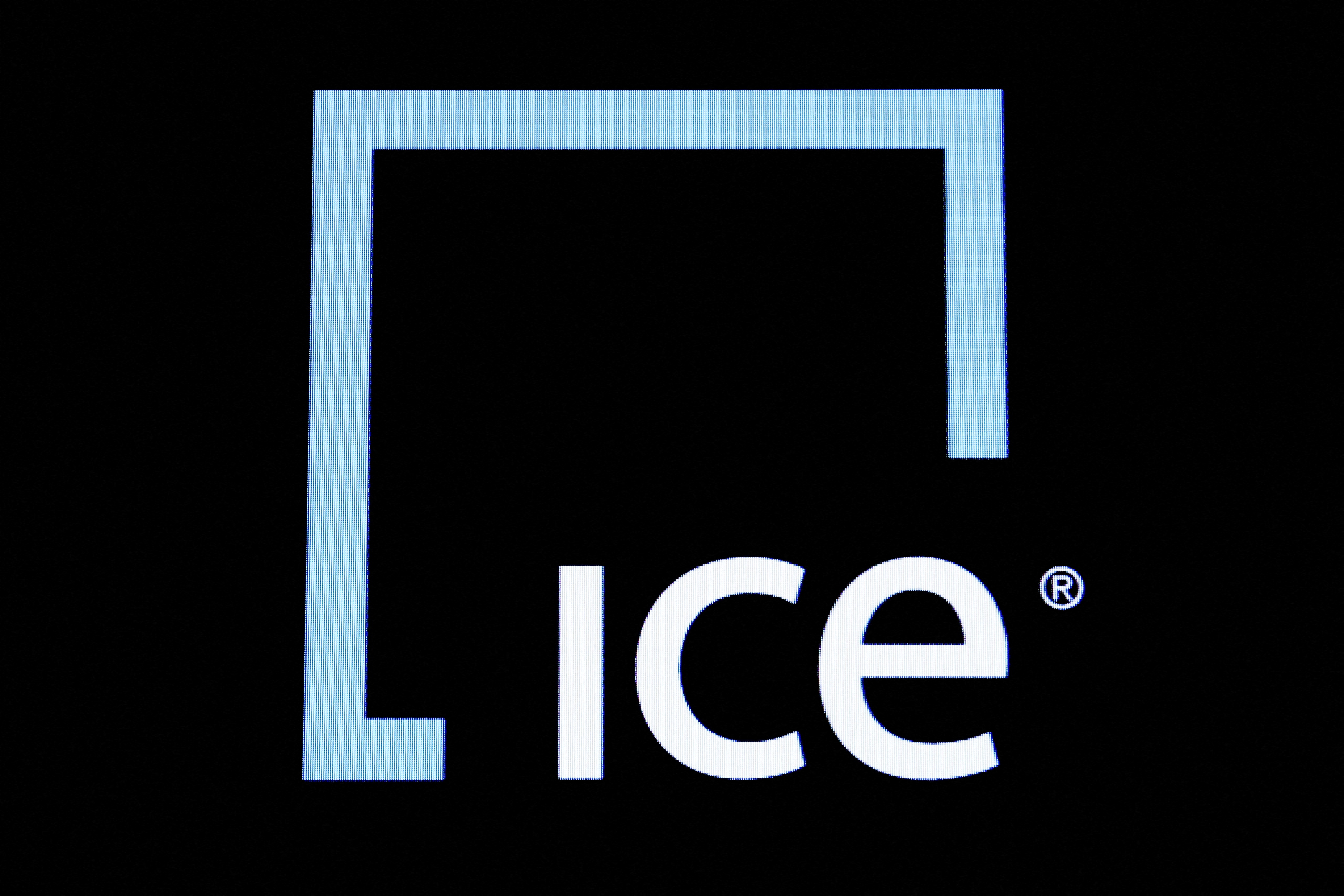 A screen displays the ticker symbol and logo for Intercontinental Exchange Inc. (ICE) on the floor of the NYSE