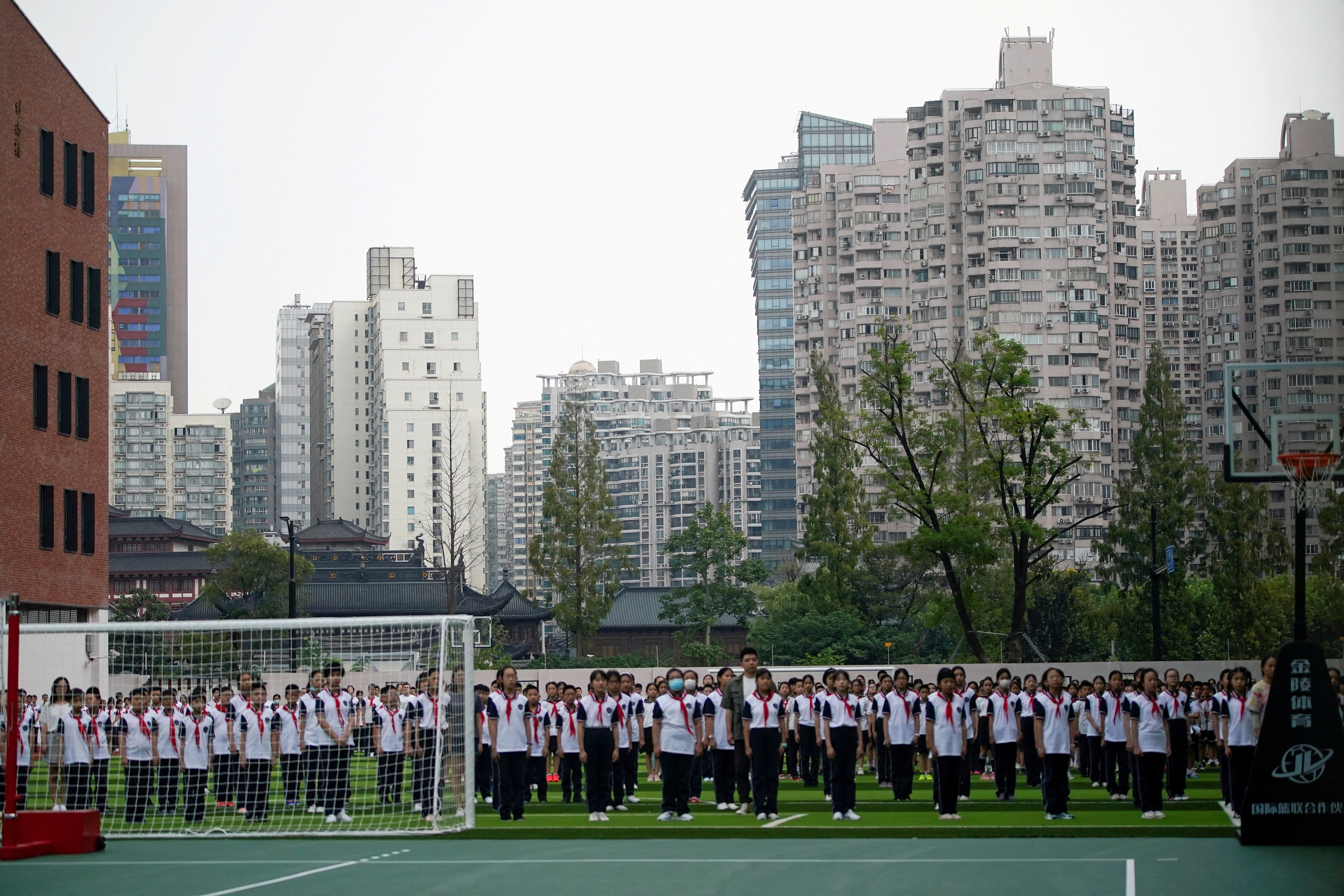 Students stand at a school on the first day of new academic year in Shanghai