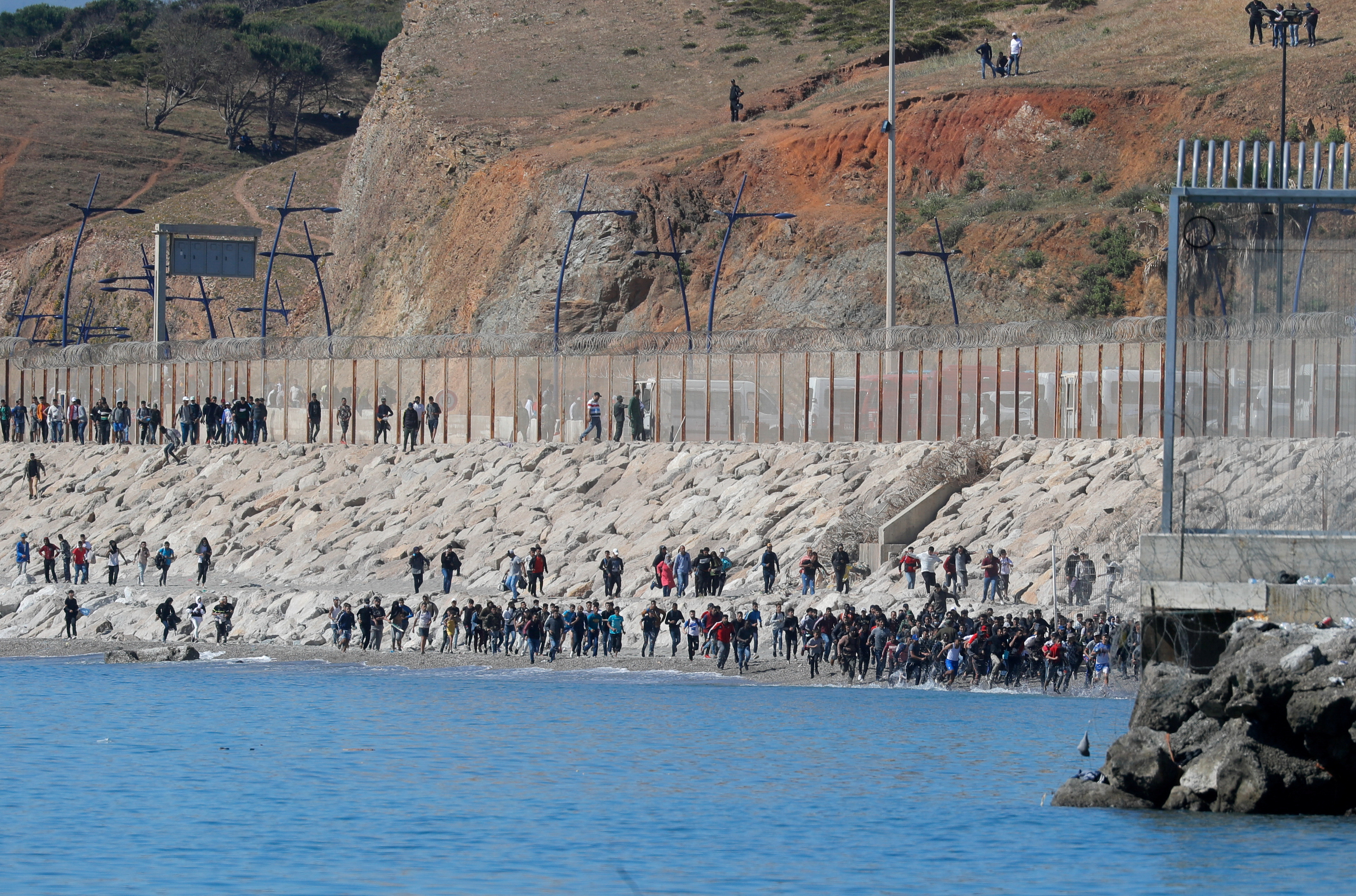 Thousands of migrants cross the Spanish-Moroccan border