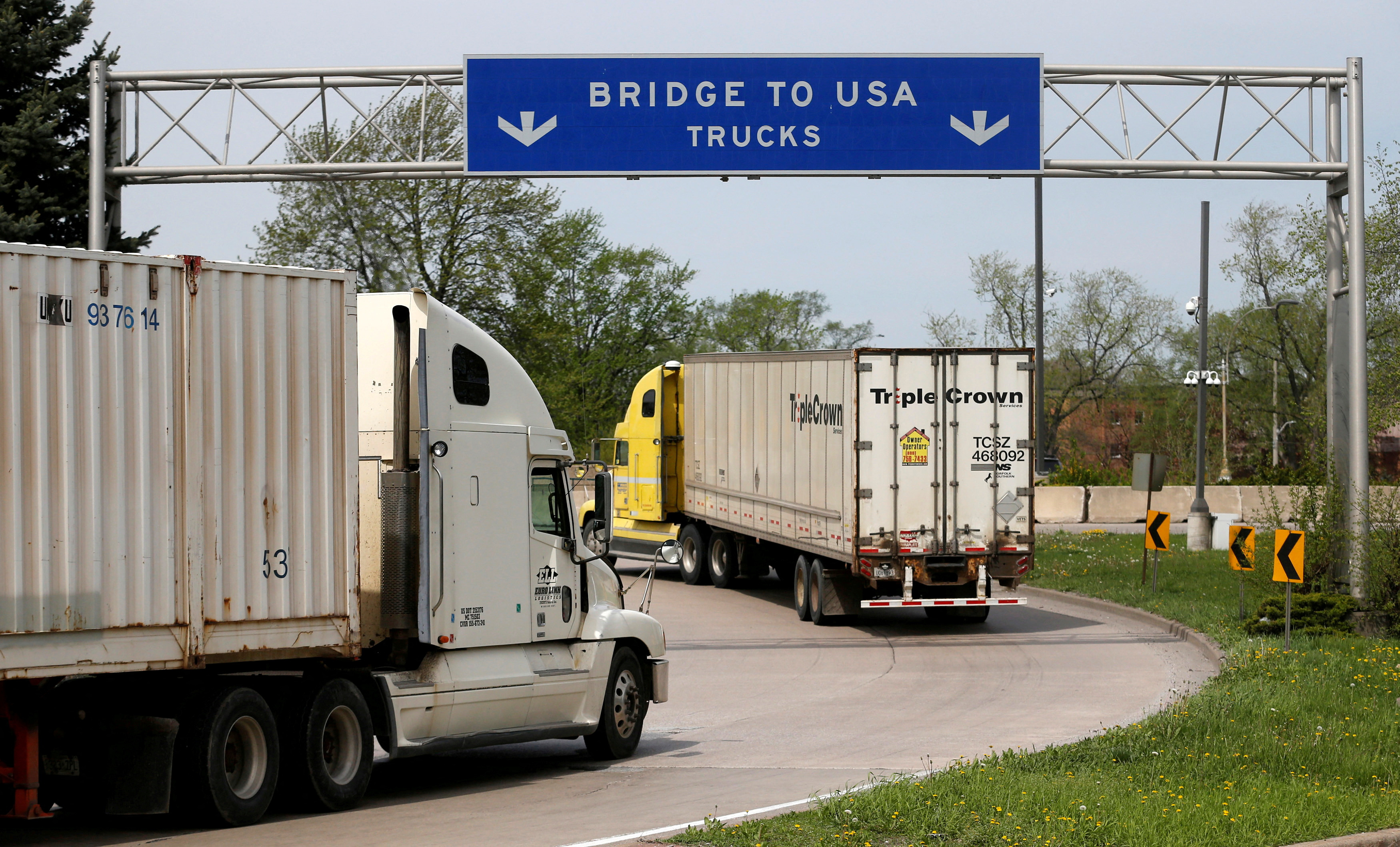 Semi trucks heading for Detroit, Michigan, drive on the lane to Ambassador Bridge in Windsor