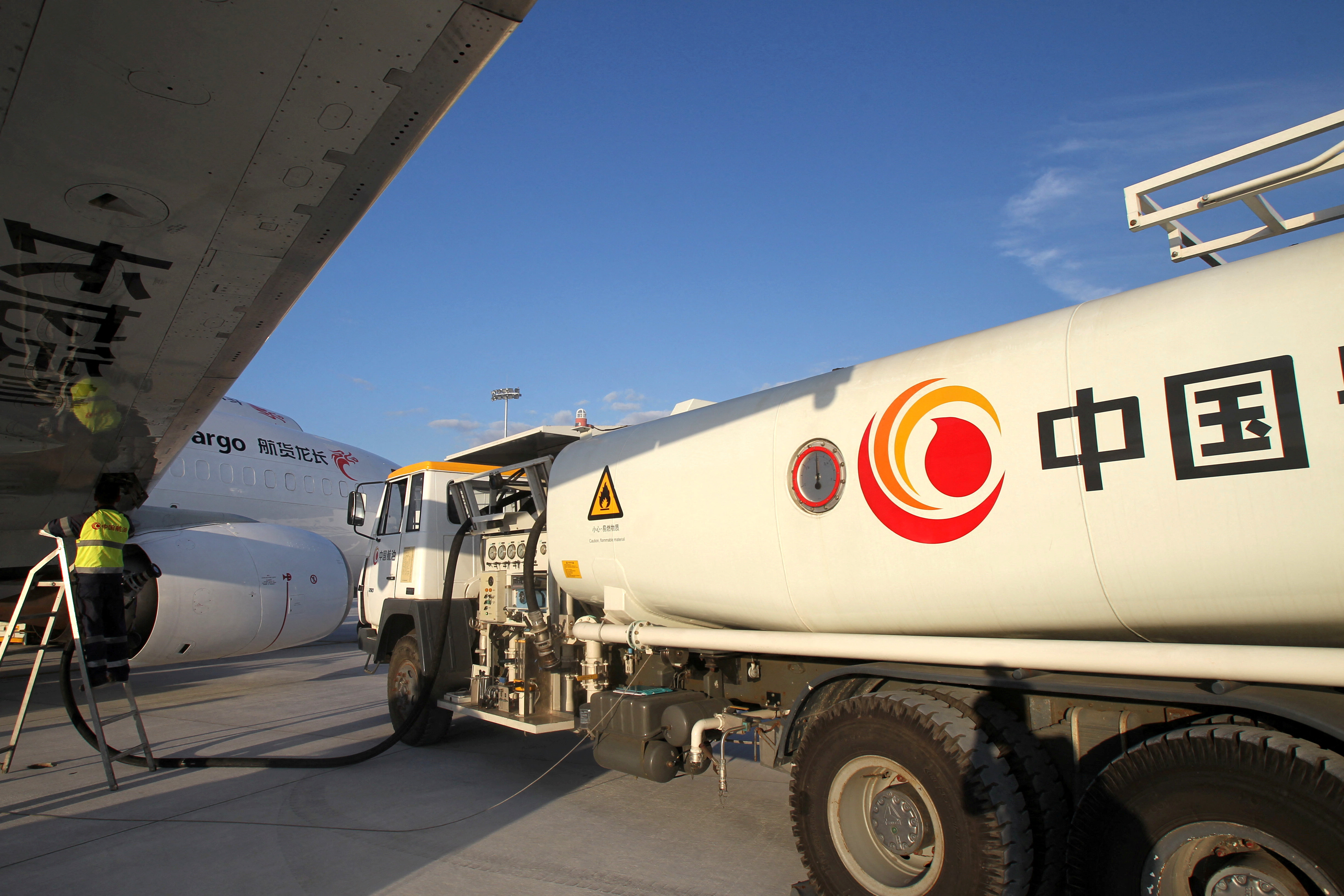 Worker refuels a cargo aircraft with aviation fuel at an airport in Nantong