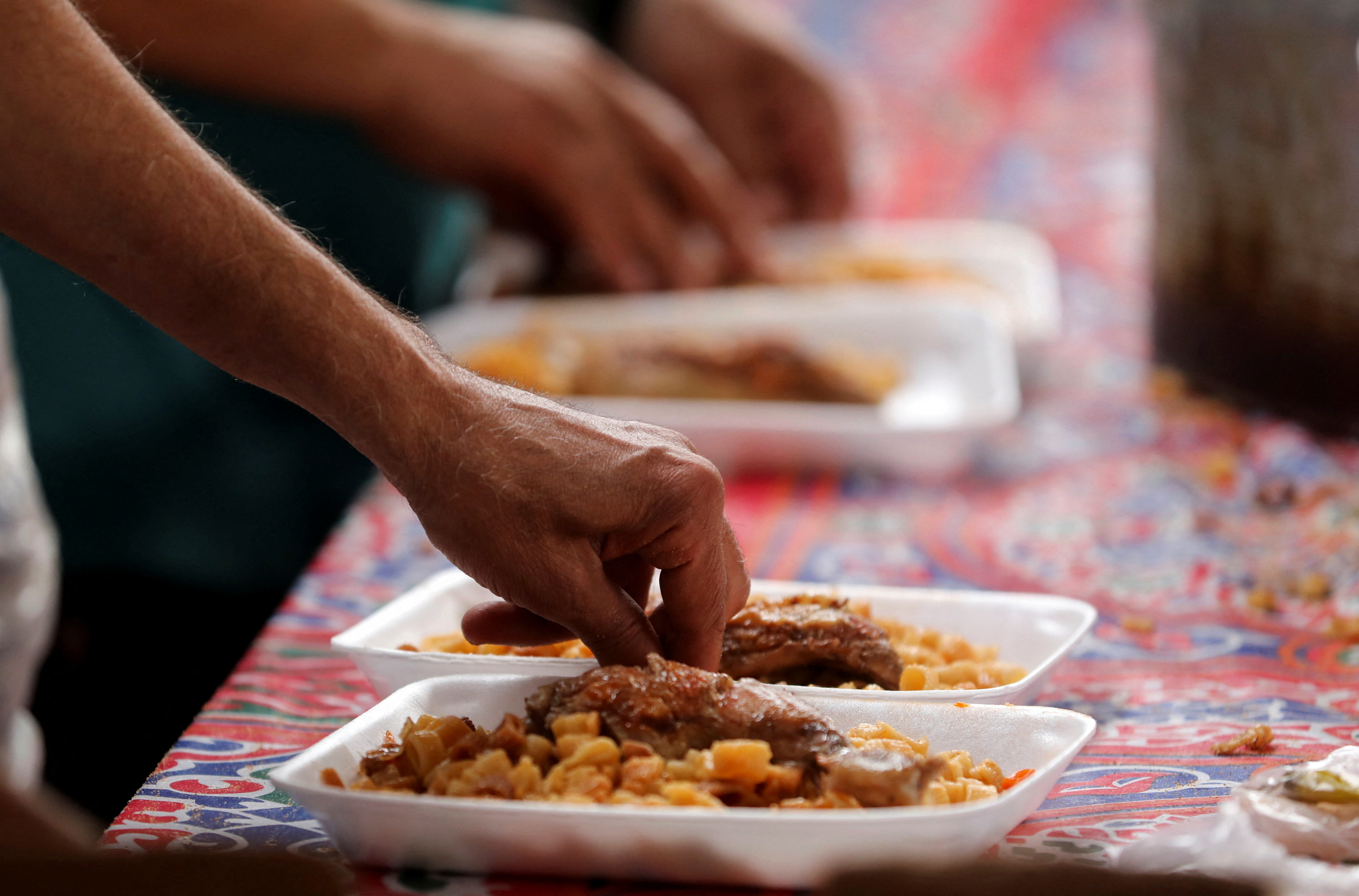 आर्थिक संकट के बीच रमजान के पवित्र महीने के दौरान काहिरा में गर्म भोजन वितरित किया जाता है
