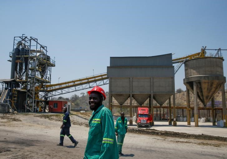Workers are seen near a processing plant at the Dorowa mine in Hwedza