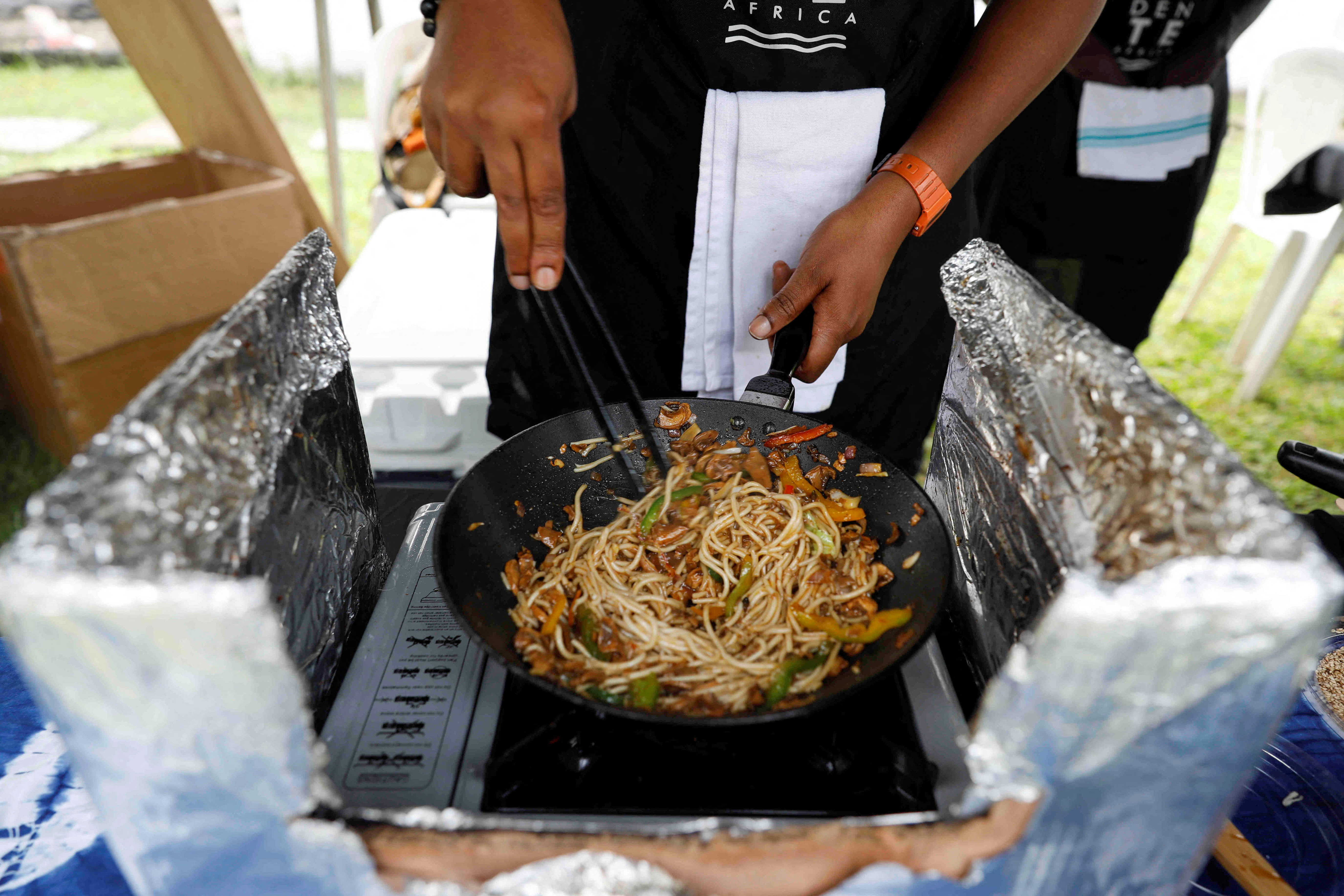 CEO of Aldente Africa Renee Chuks cooks gluten-free pasta made of cassava for a customer during a weekly farmers' market in Ikoyi, Lagos
