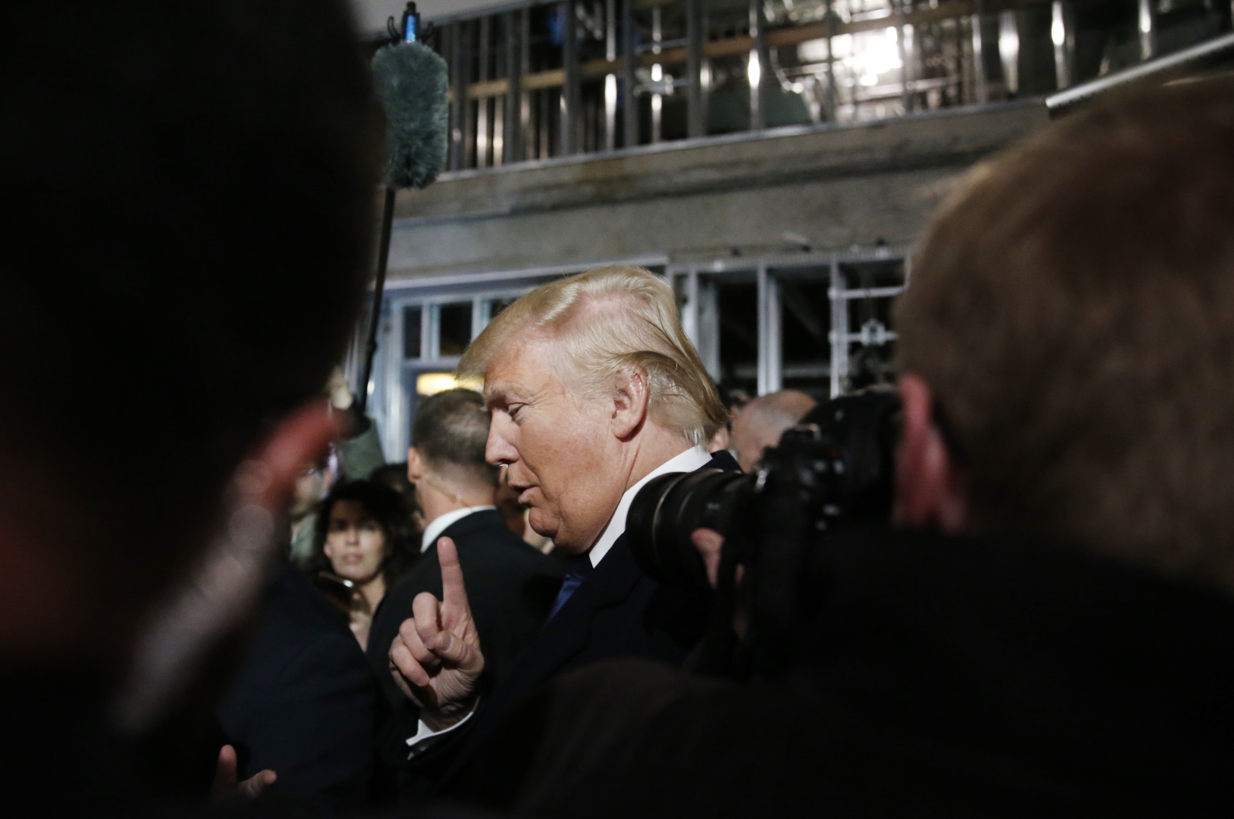 Republican U.S. presidential candidate Trump speaks to reporters while touring Trump  Hotel construction site in Washington