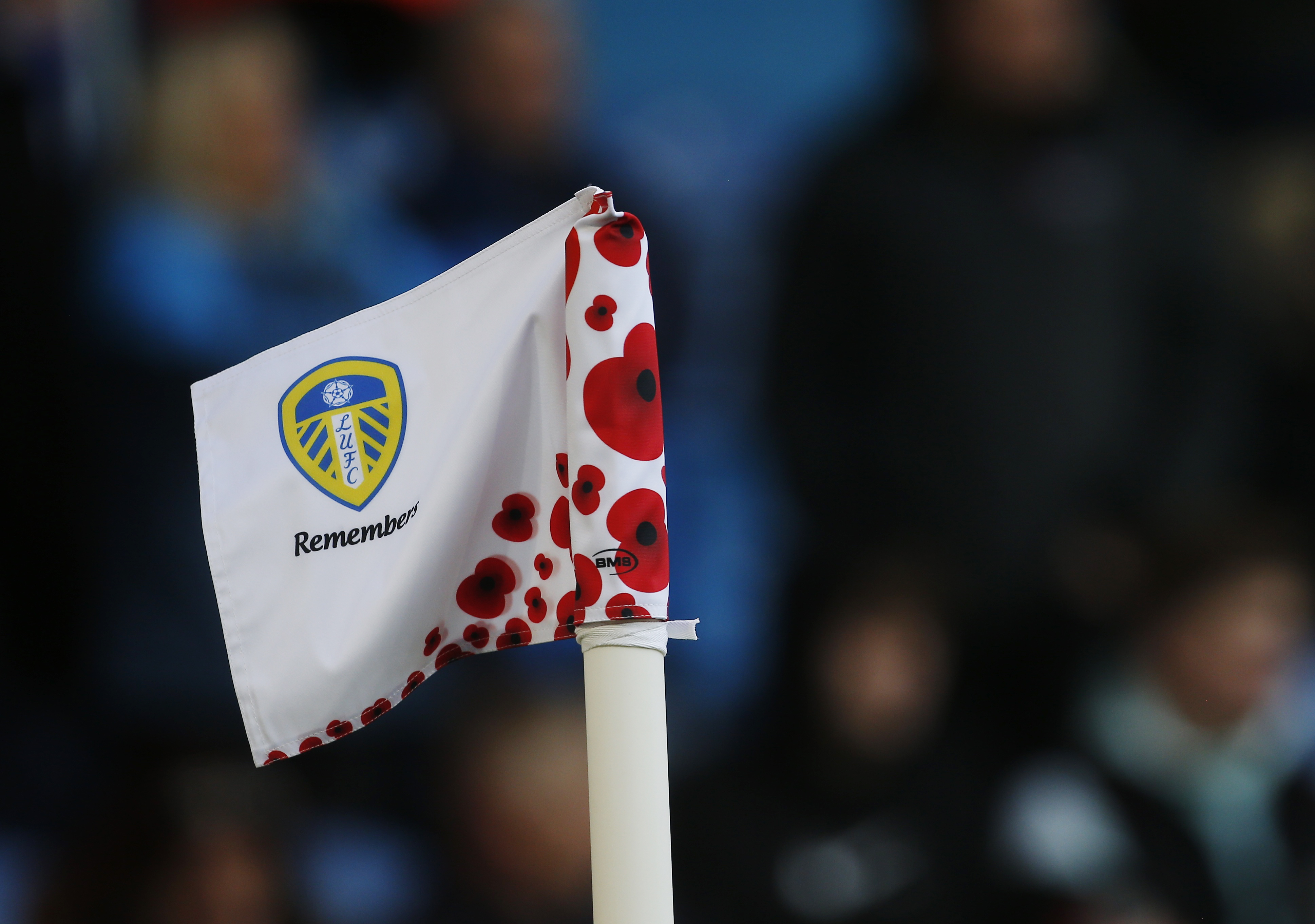 Soccer Football - Premier League - Leeds United v Leicester City - Elland Road, Leeds, Britain - November 7, 2021 Leeds United corner flag is seen with poppies as part of remembrance commemorations before the match. REUTERS/Craig Brough