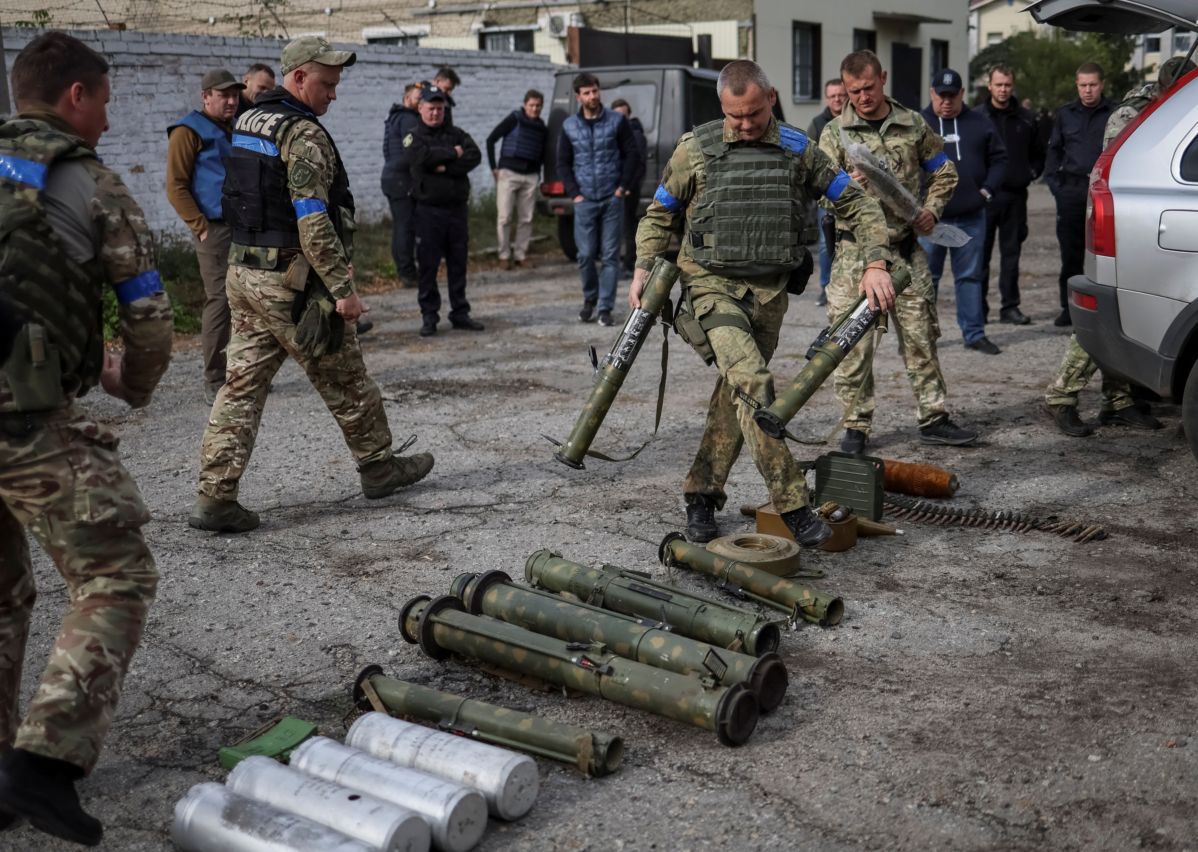 A police sapper sorts unexploded mine shells and weapons after return from the village of Udy, recently liberated by Ukrainian Armed Forces, in the town of Zolochiv