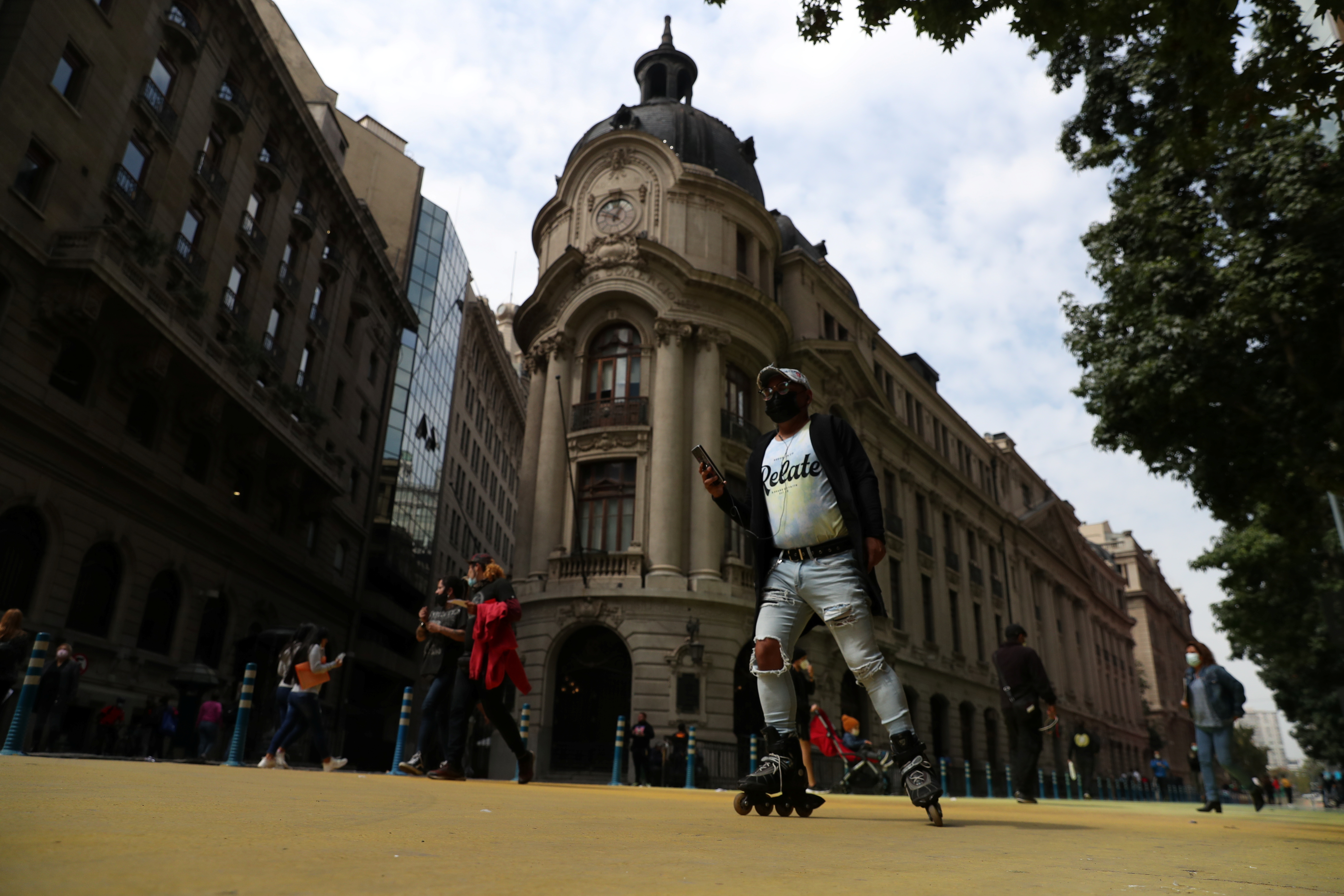 A man roller skates in front of Santiago's stock exchange building, in downtown Santiago